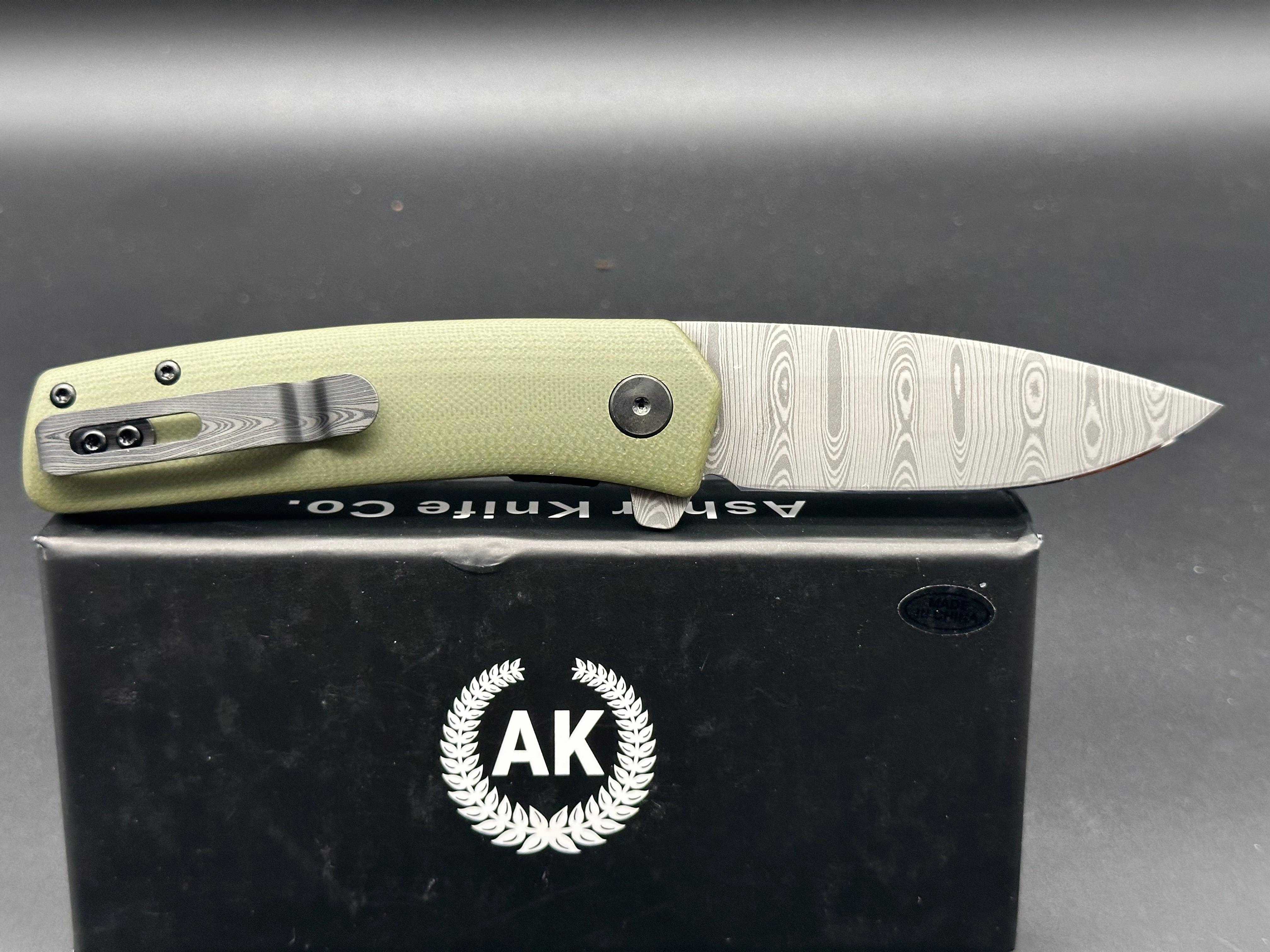 Asher Knives The Spiro flipper OD green G10 S35VN LNIB - blem Lasered ladder damascus