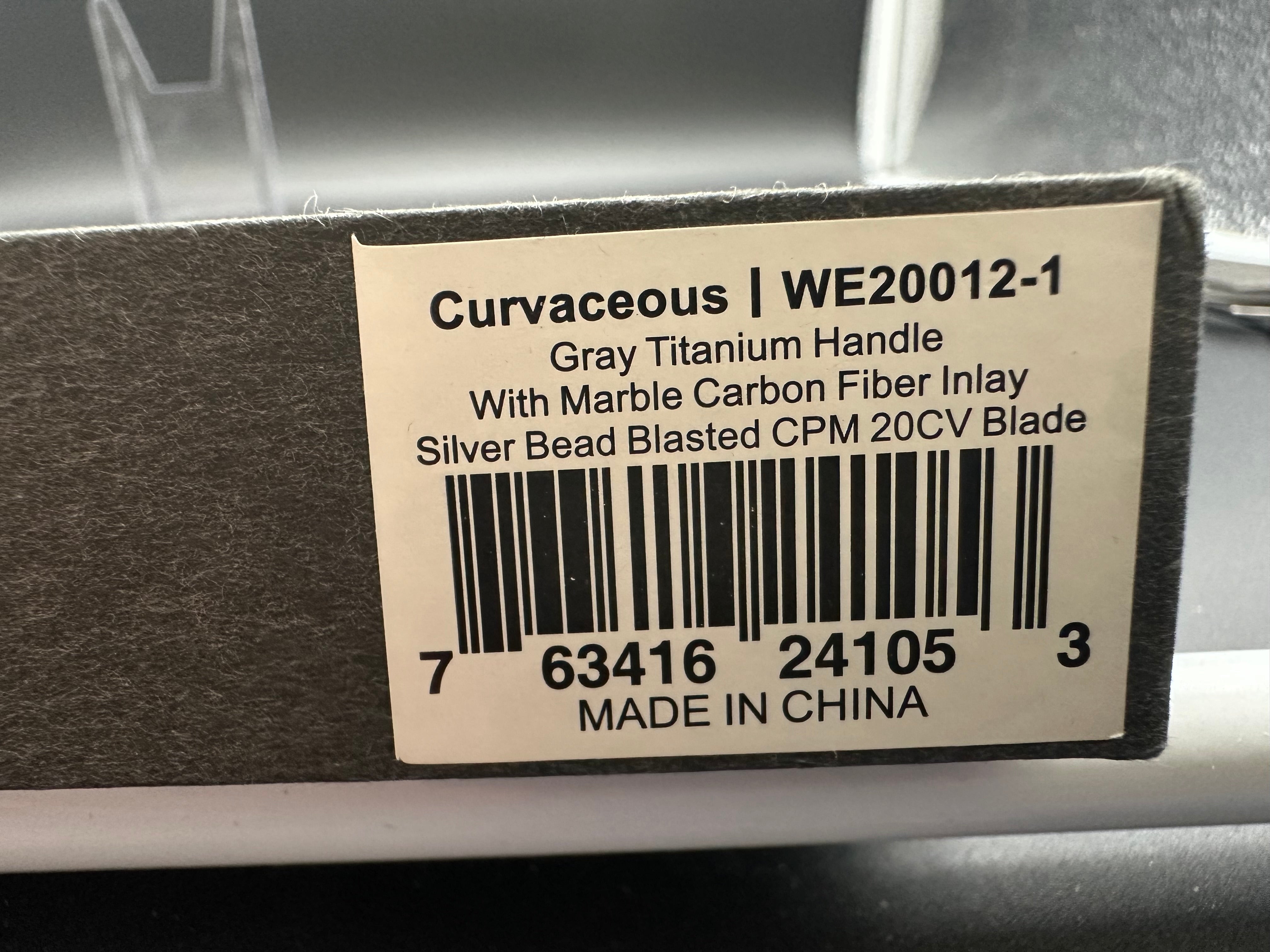 WE CURVACEOUS FOLDING KNIFE TITANIUM/MARBLE CARBON FIBER HANDLE 20CV PLAIN EDGE