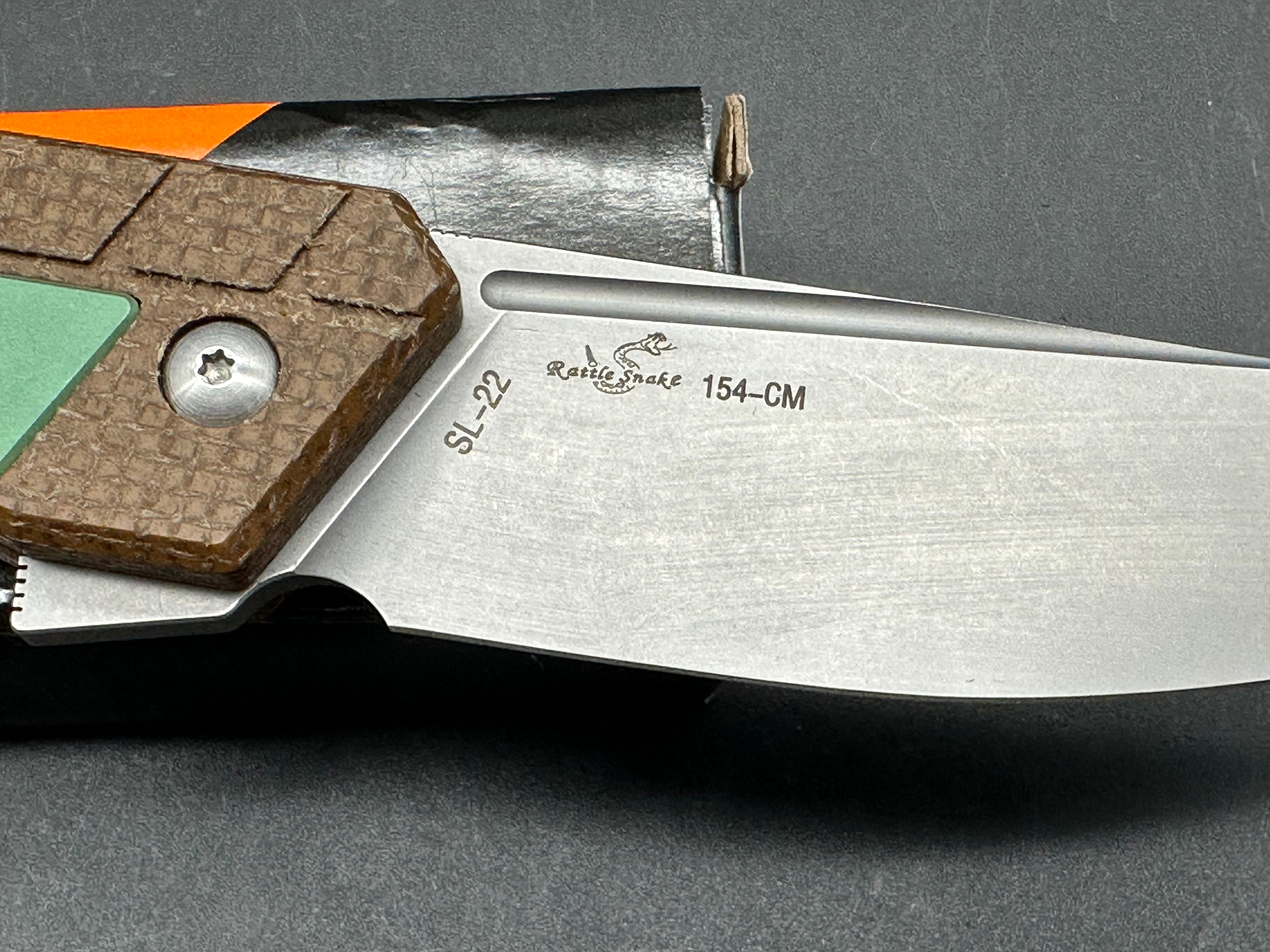 Sixleaf SL-22 GR Rattlesnake design, button lock, micarta scales with green titanium inserts and pocket clip, 154-CM blade