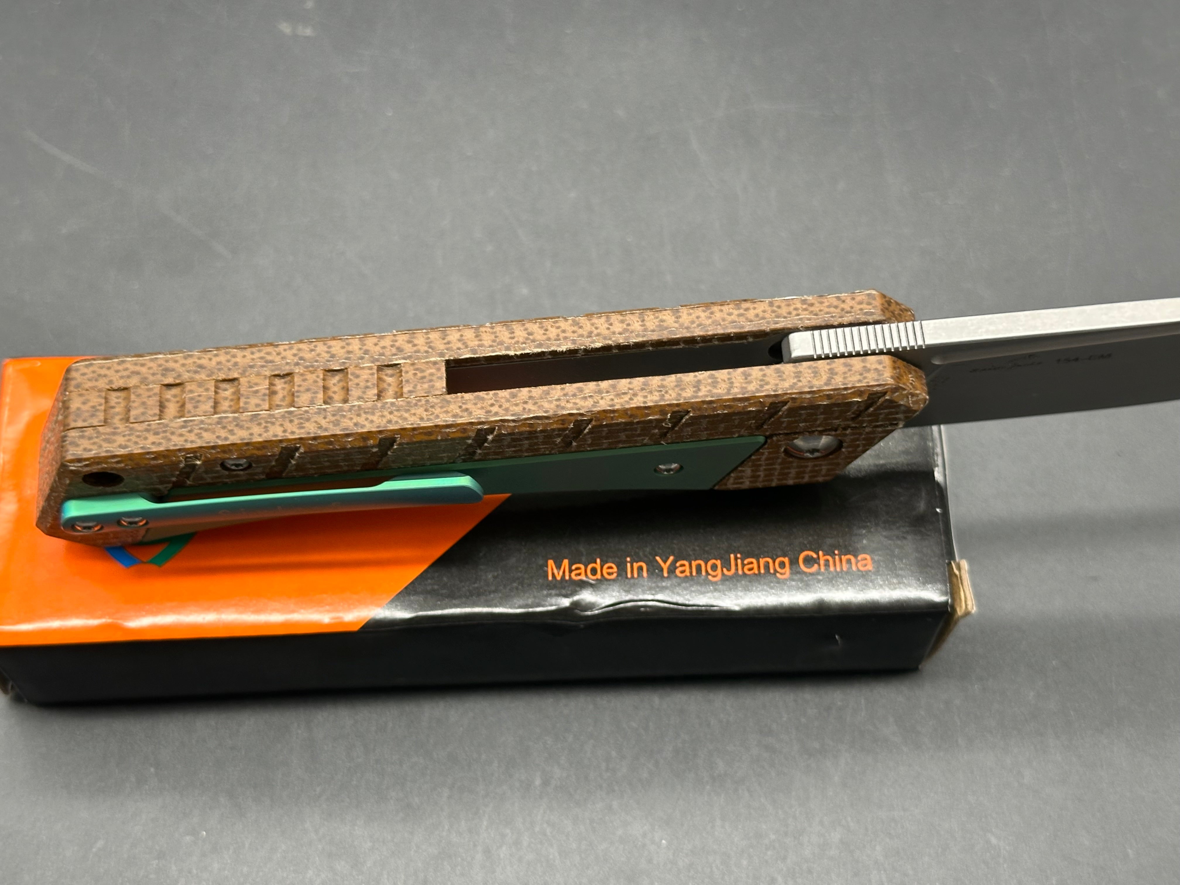Sixleaf SL-22 GR Rattlesnake design, button lock, micarta scales with green titanium inserts and pocket clip, 154-CM blade