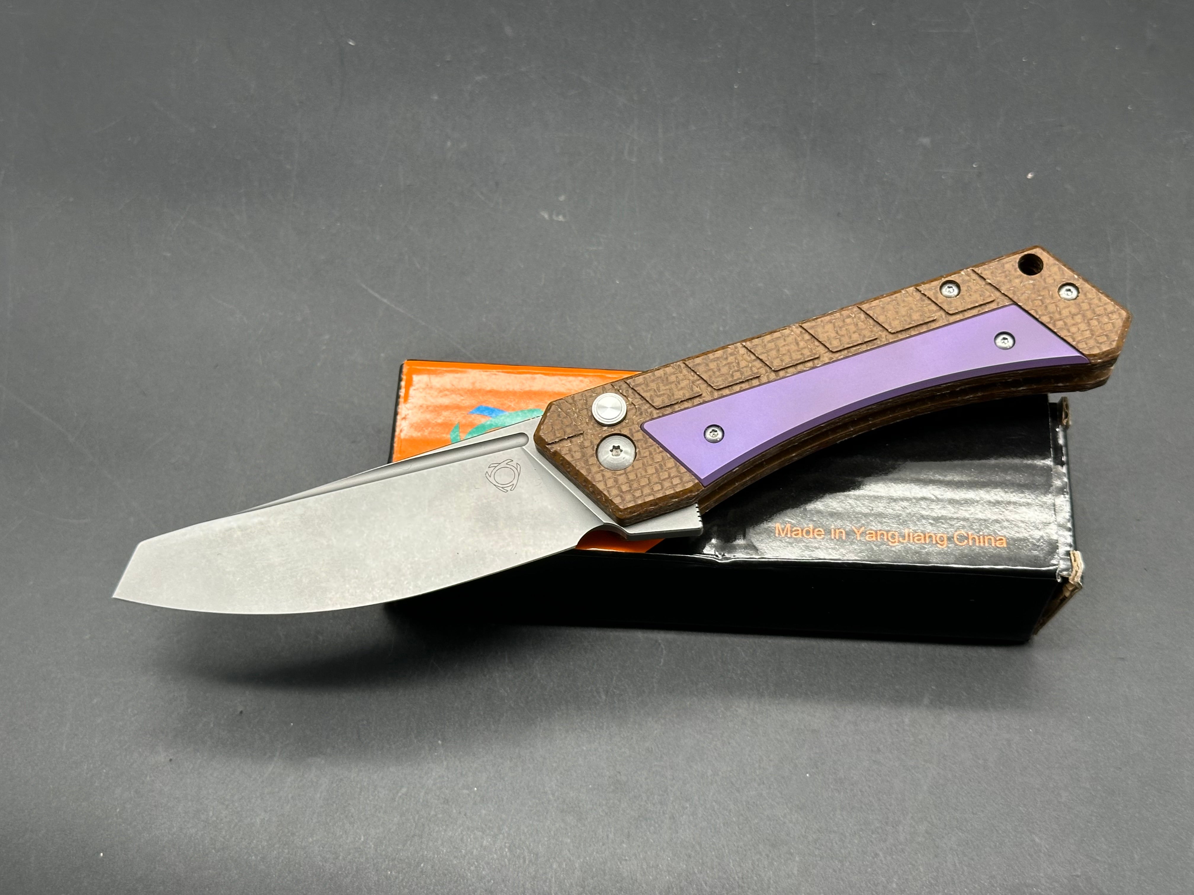 Sixleaf SL-22 PR Rattlesnake design, button lock, micarta scales with purple titanium inserts and pocket clip, 154-CM blade