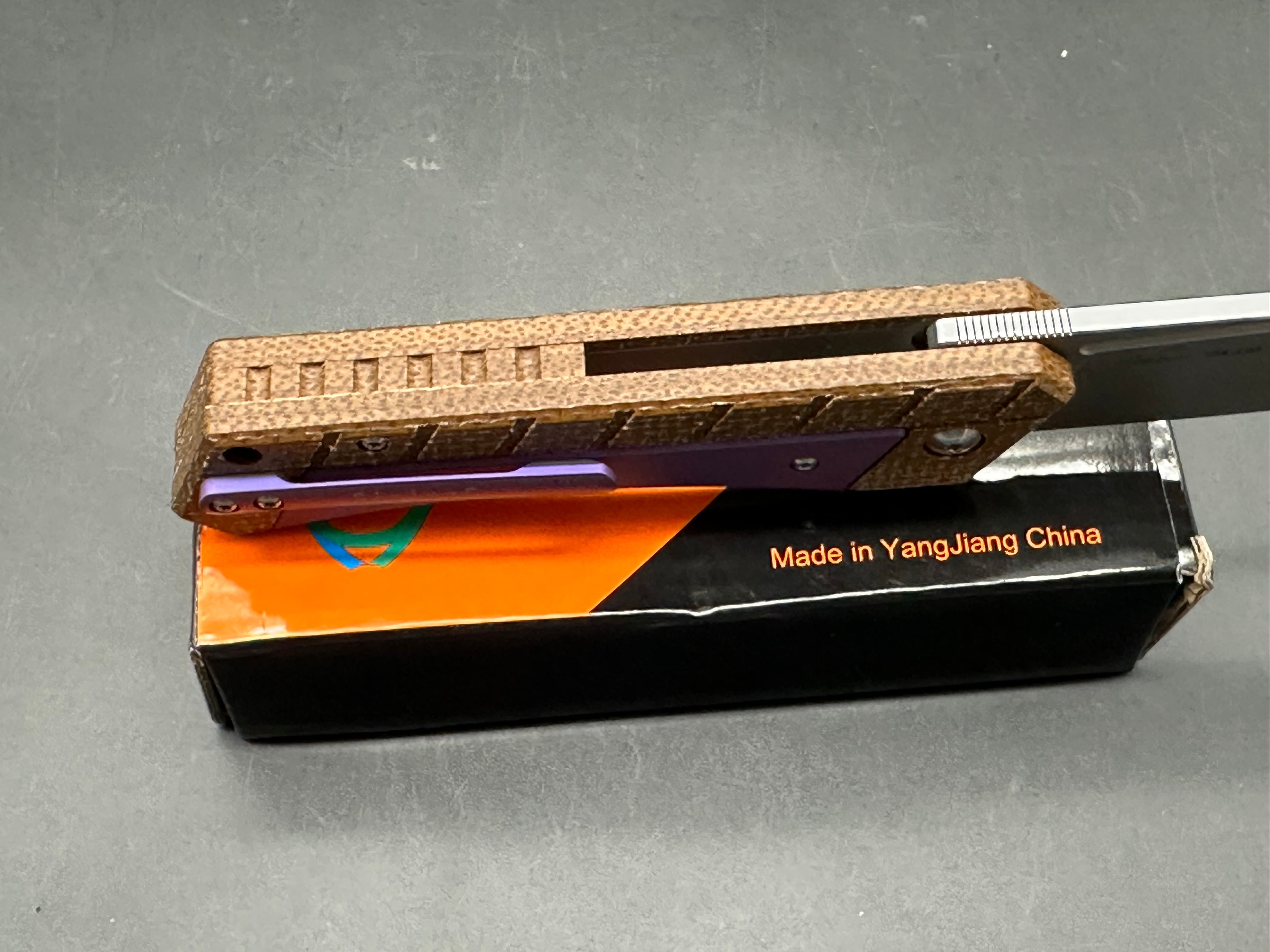 Sixleaf SL-22 PR Rattlesnake design, button lock, micarta scales with purple titanium inserts and pocket clip, 154-CM blade