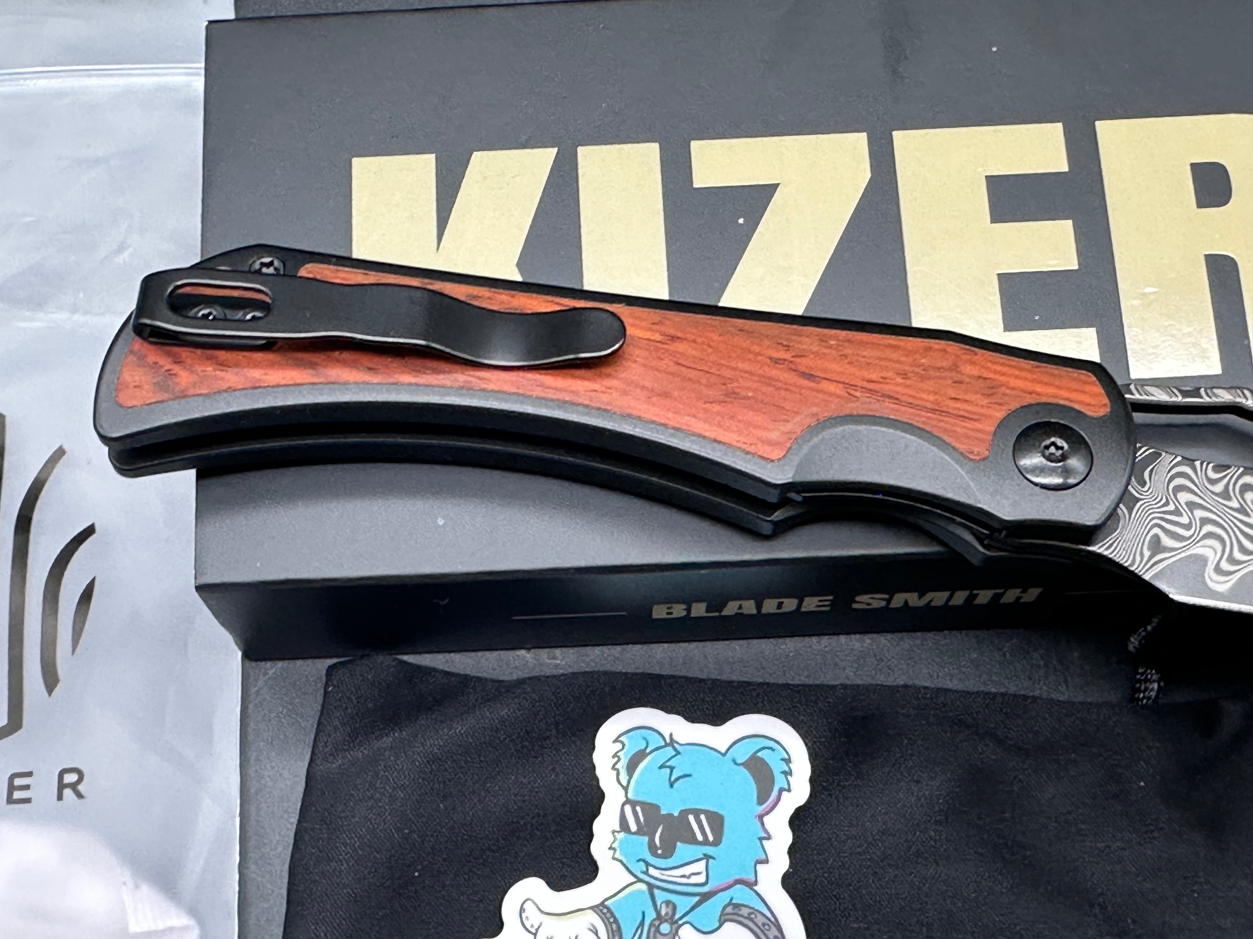 KIZER ALLURE FOLDING KNIFE TITANIUM/PANAMA ROSEWOOD HANDLE DAMASCUS DROP POINT PLAIN EDGE ACID WASH FINISH