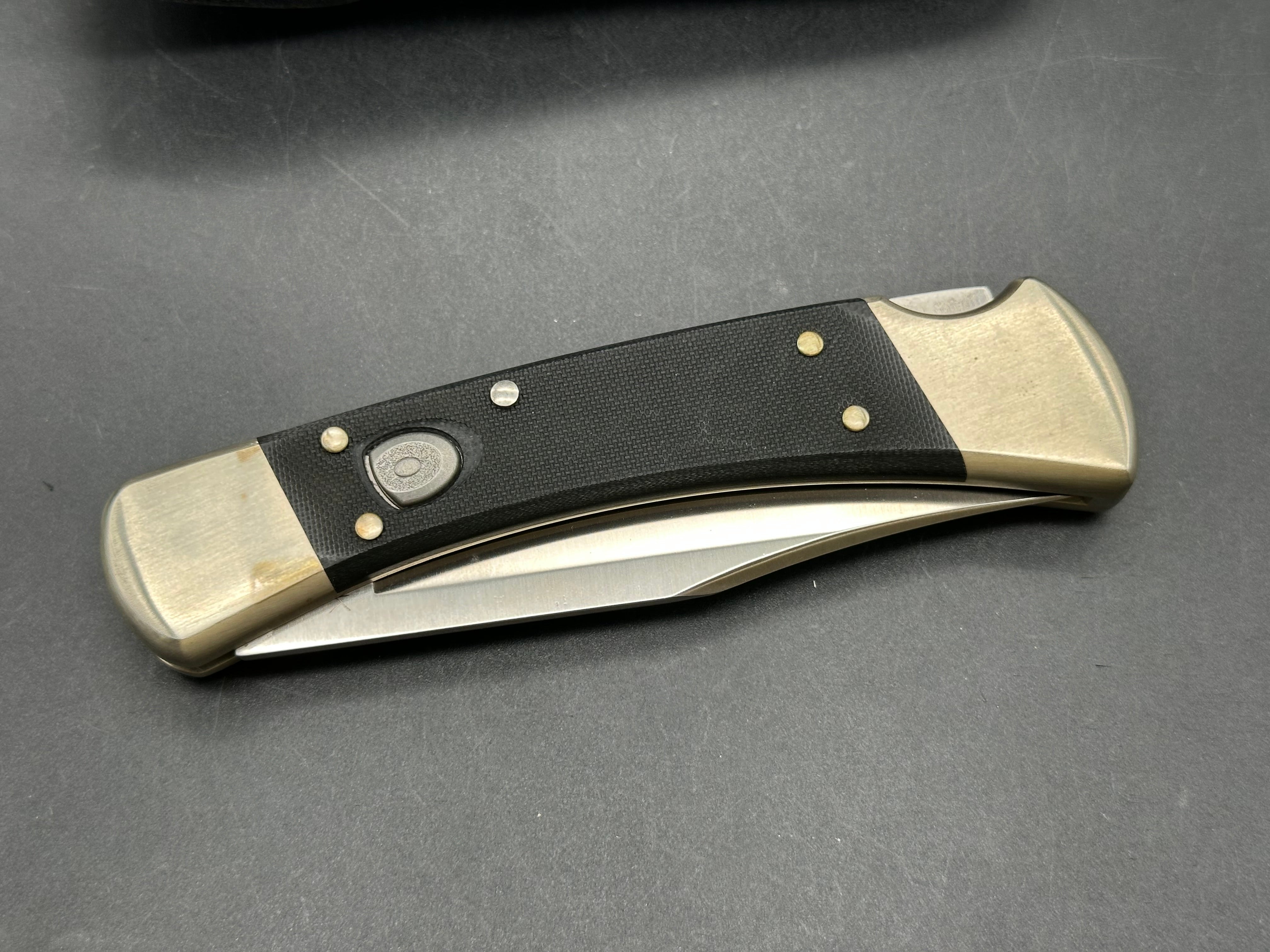 Buck 110 Auto, black G-10 scales, nickel bolsters, with scabbard