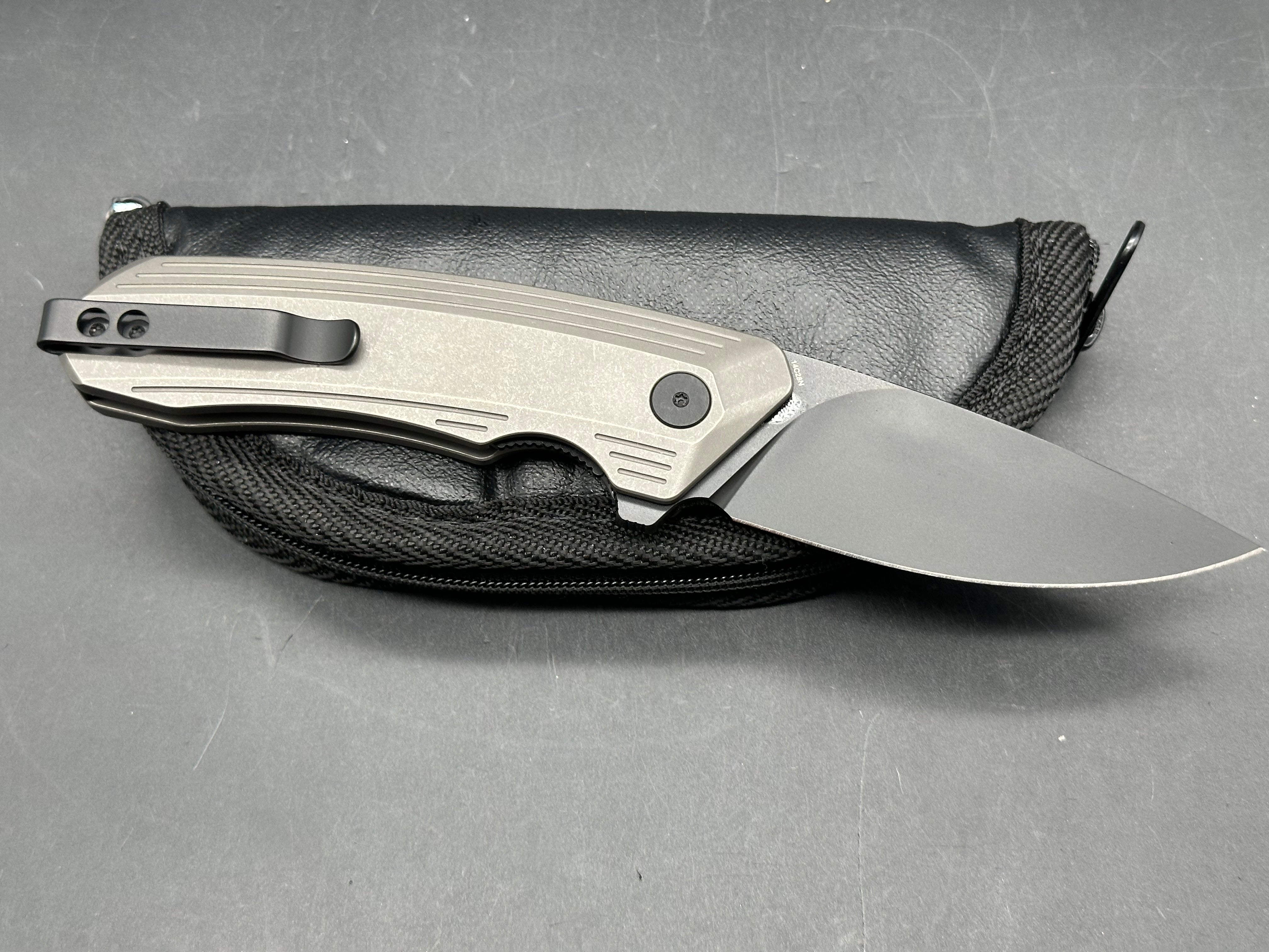 Damned Designs Invictus 3.5 inch 14C28N DLC coated blade. Titanium frame