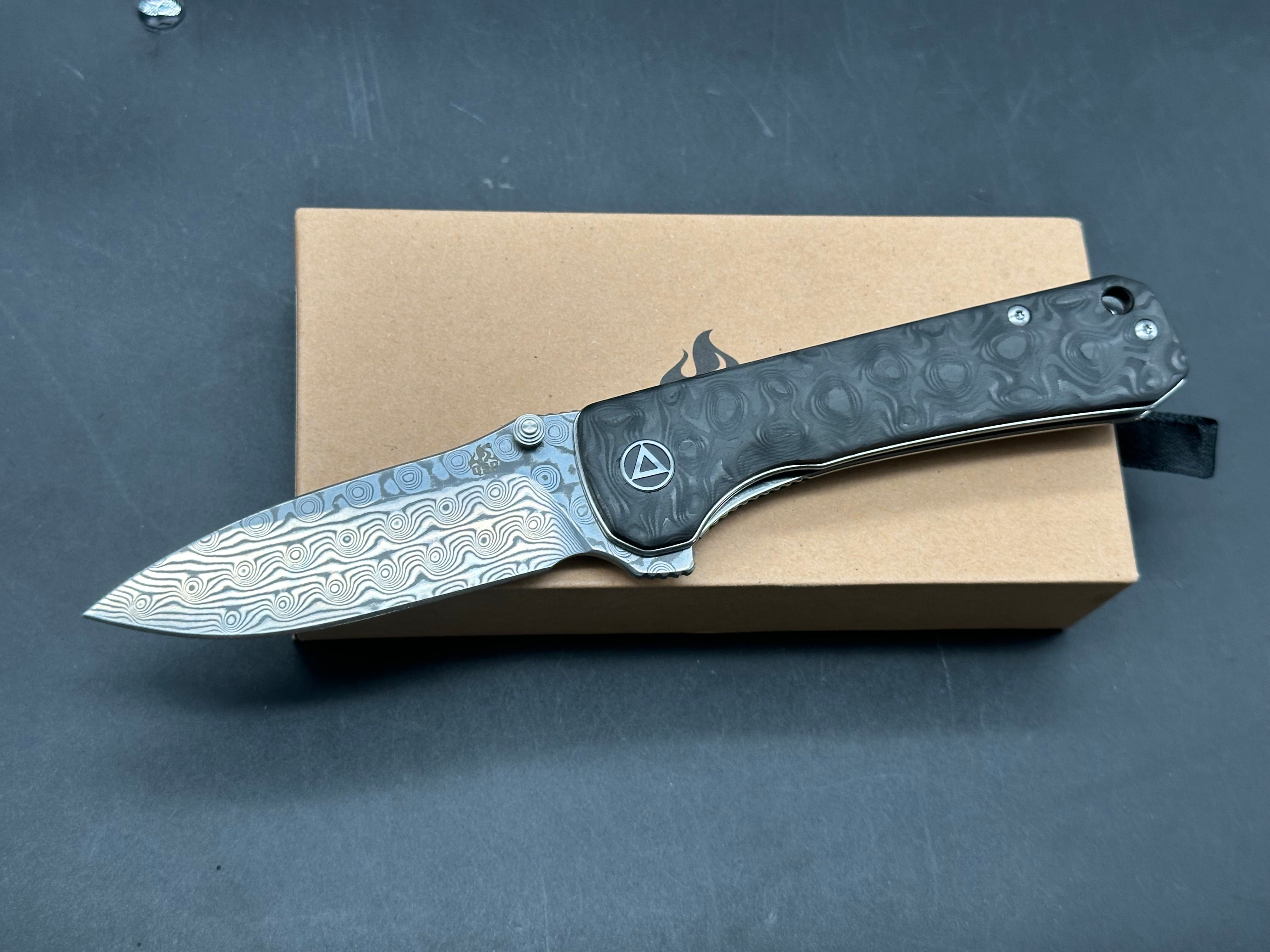 QSP Hawk 3.25 drop point, flat grind Damascus blade. Ceramic ball bearings. Marbled carbon fiber scales