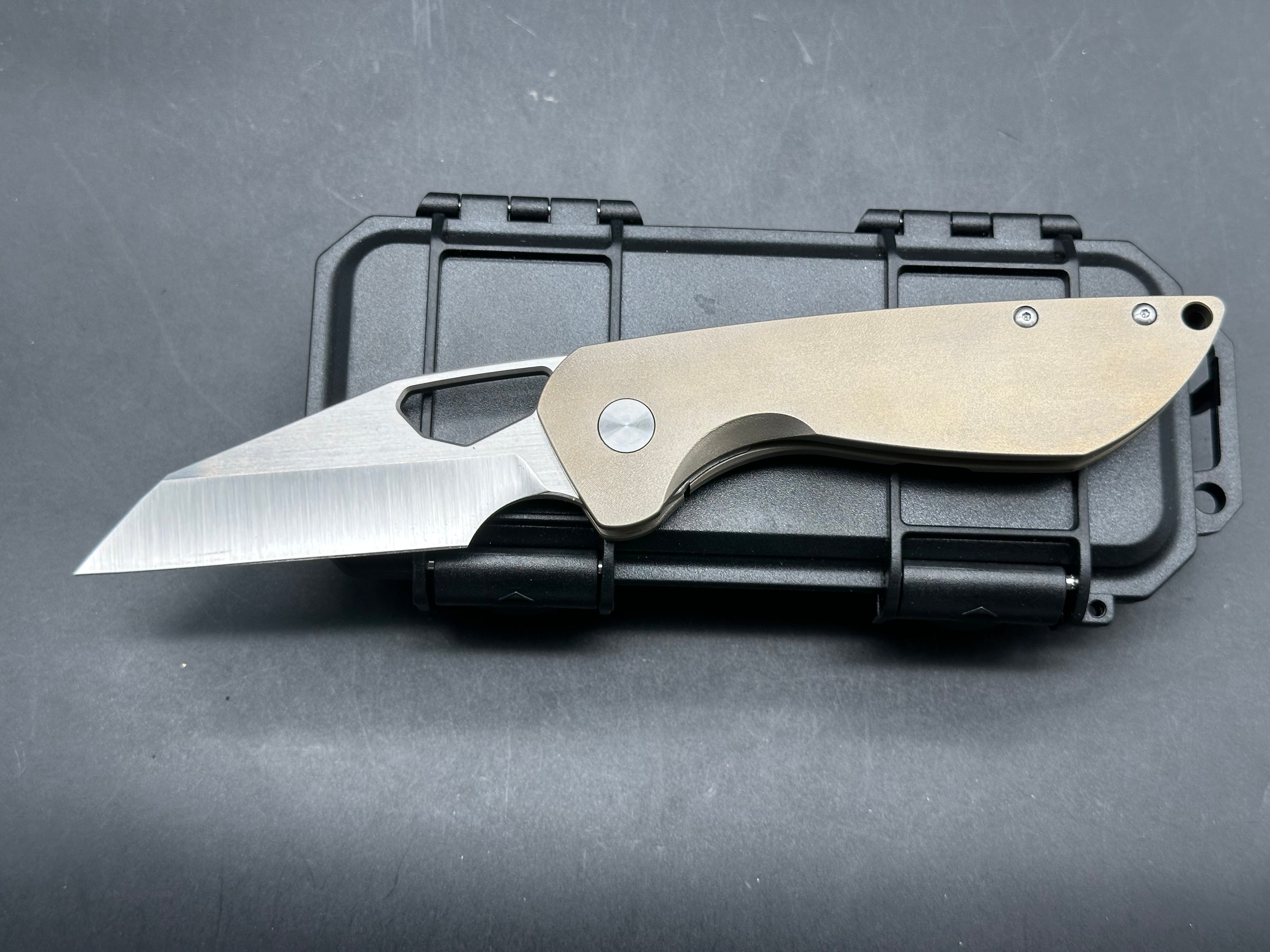Tuyaknife Voodoo 3.25 inch satin finish Wharncliffe CPM-S90V blade. Orange peel titanium handle
