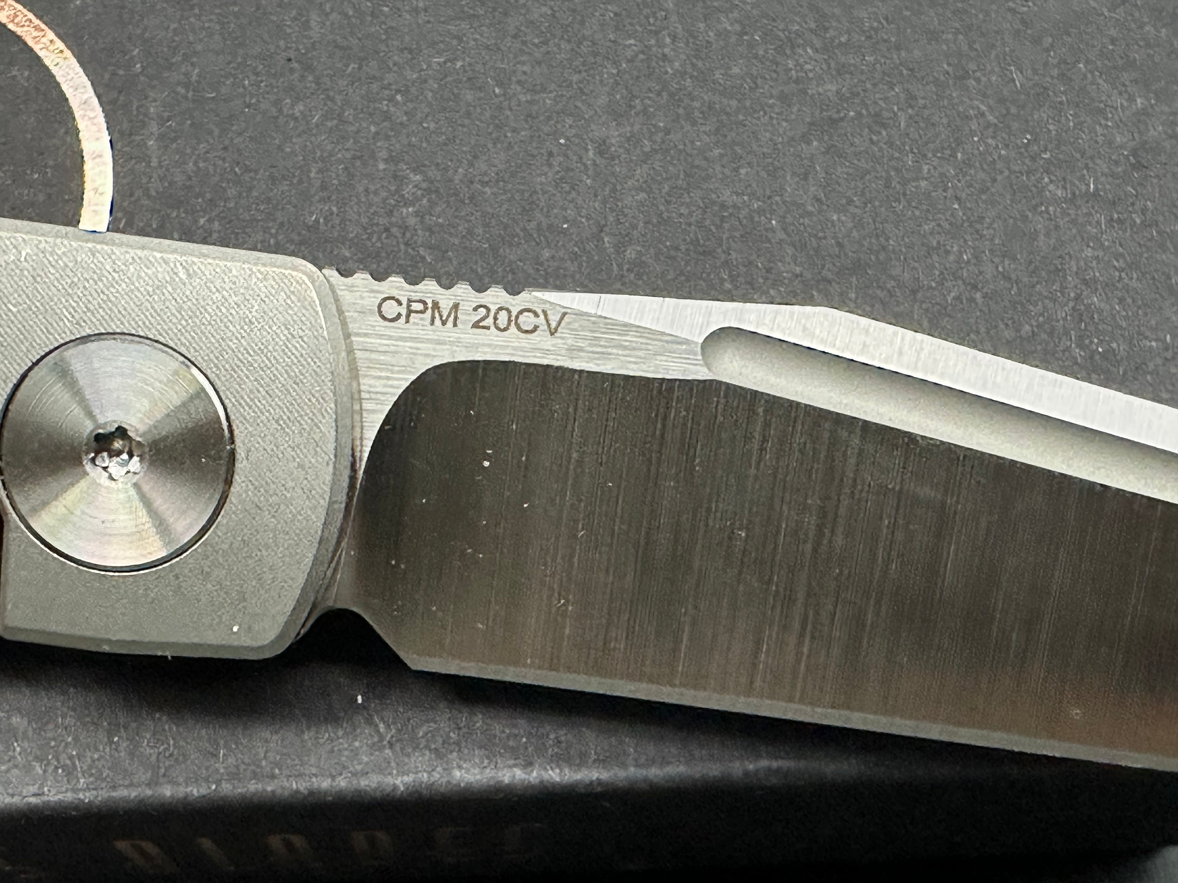 Adam Purvis Rook 3.3 inch vertical belt sanded CPM-20CV blade. Titaniu scales with marbled carbon fiber inlays. Satin hardware