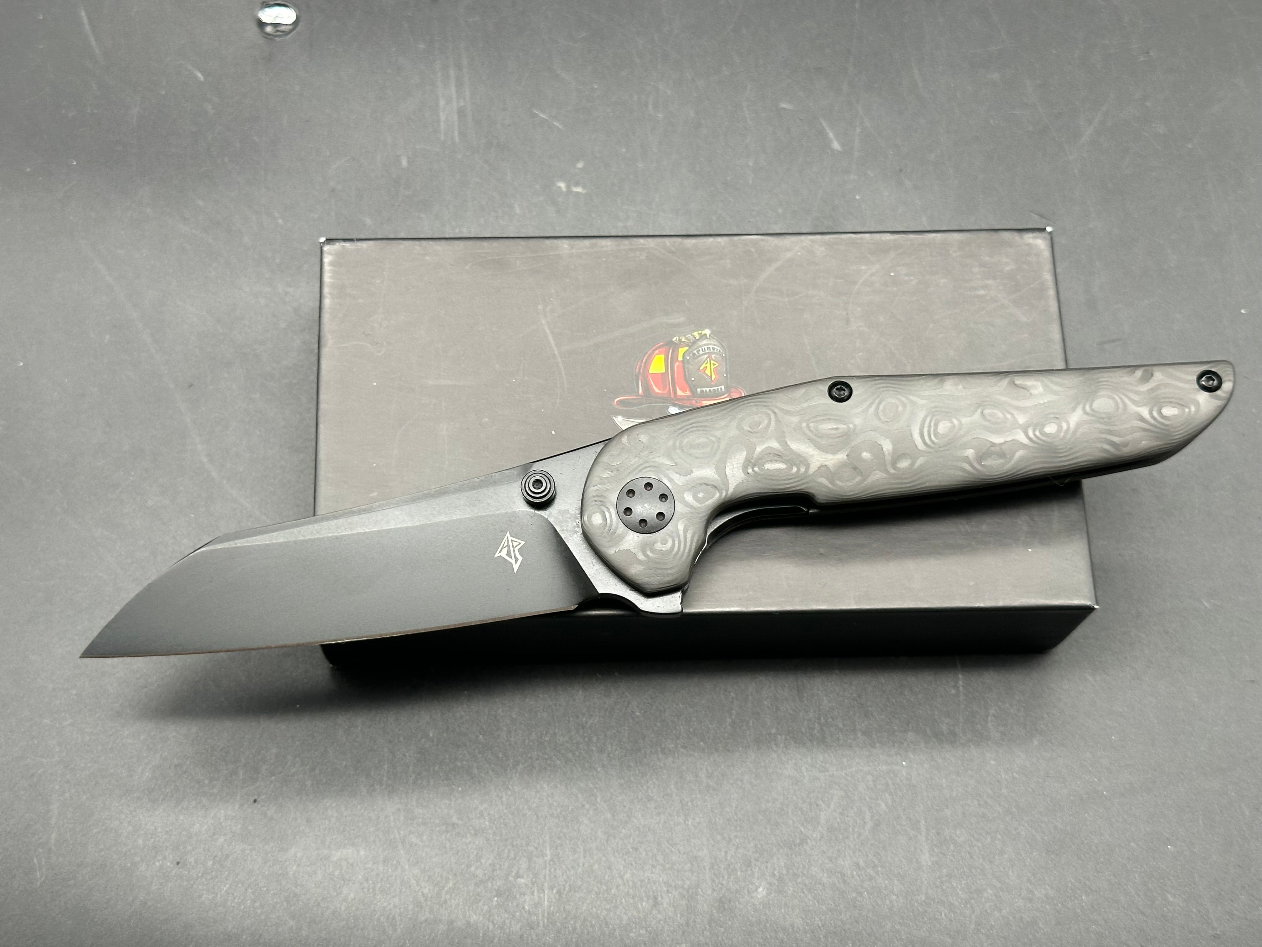 Adam Purvis Progeny 3.5 inch blackwashed, M390 blade. Raindrop carb fiber scales