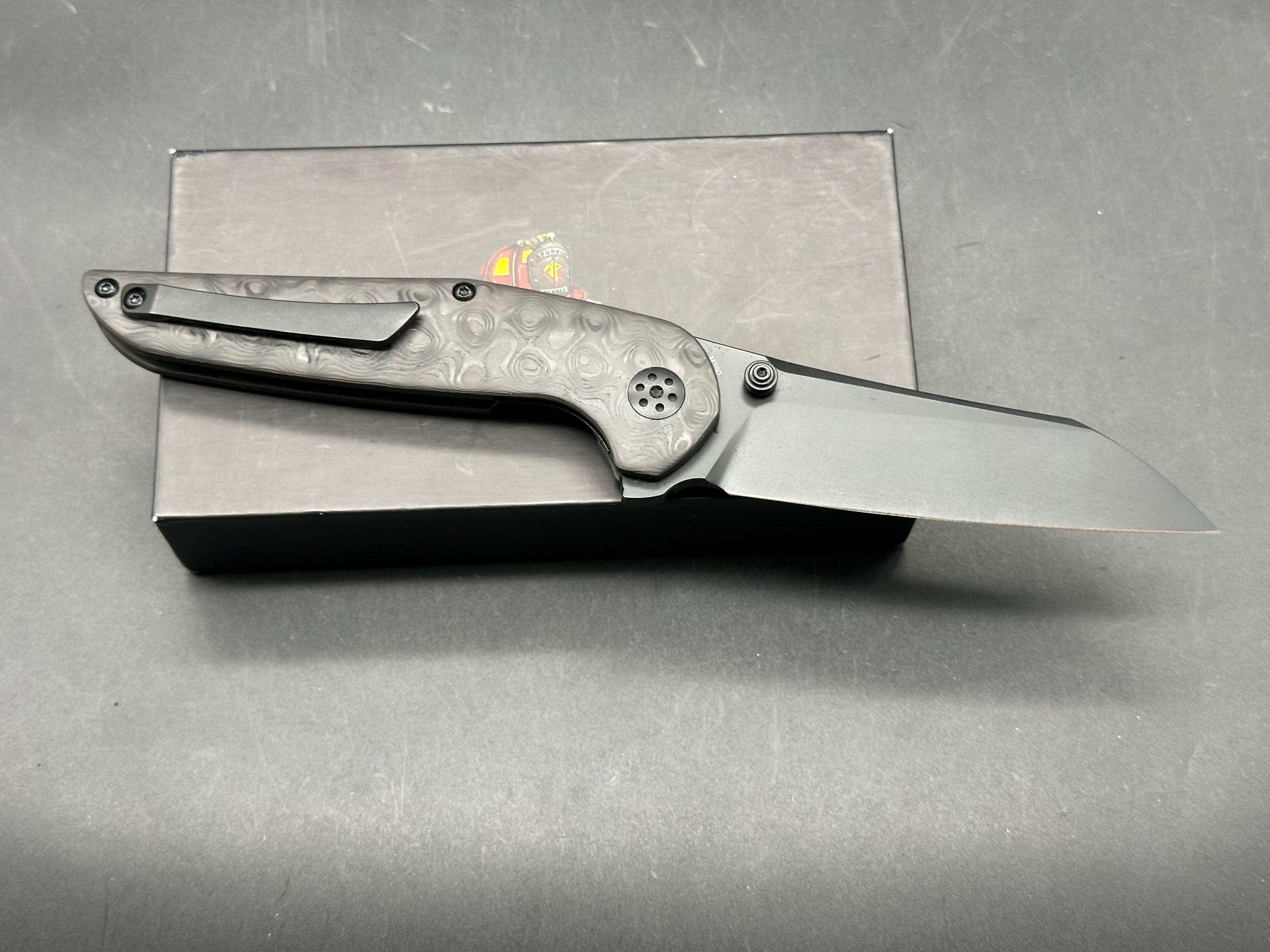 Adam Purvis Progeny 3.5 inch blackwashed, M390 blade. Raindrop carb fiber scales