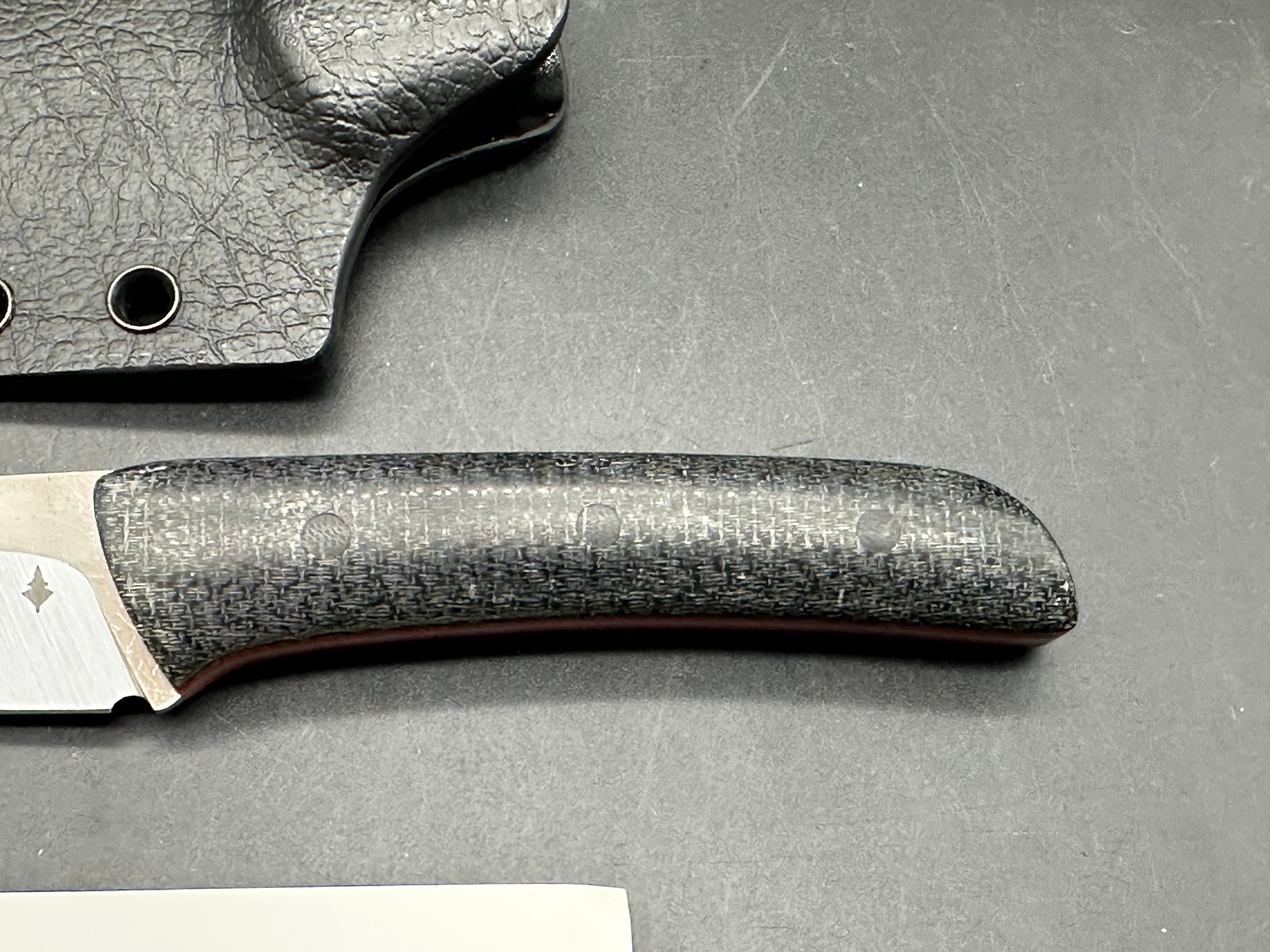 Northern Knifeworks Mink K390. Black Micarta scales with red G-10 liners. Tru-Hide kydex sheath