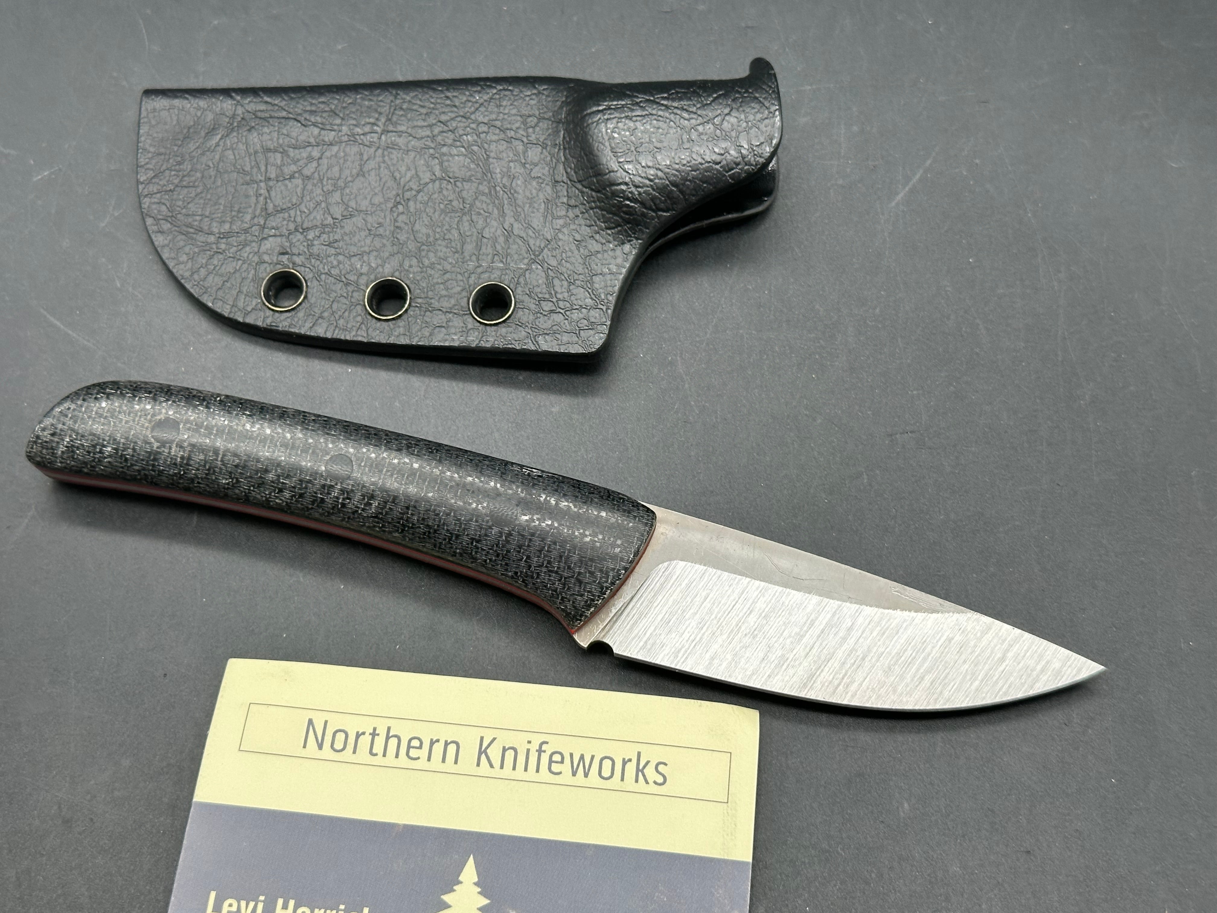 Northern Knifeworks Mink K390. Black Micarta scales with red G-10 liners. Tru-Hide kydex sheath