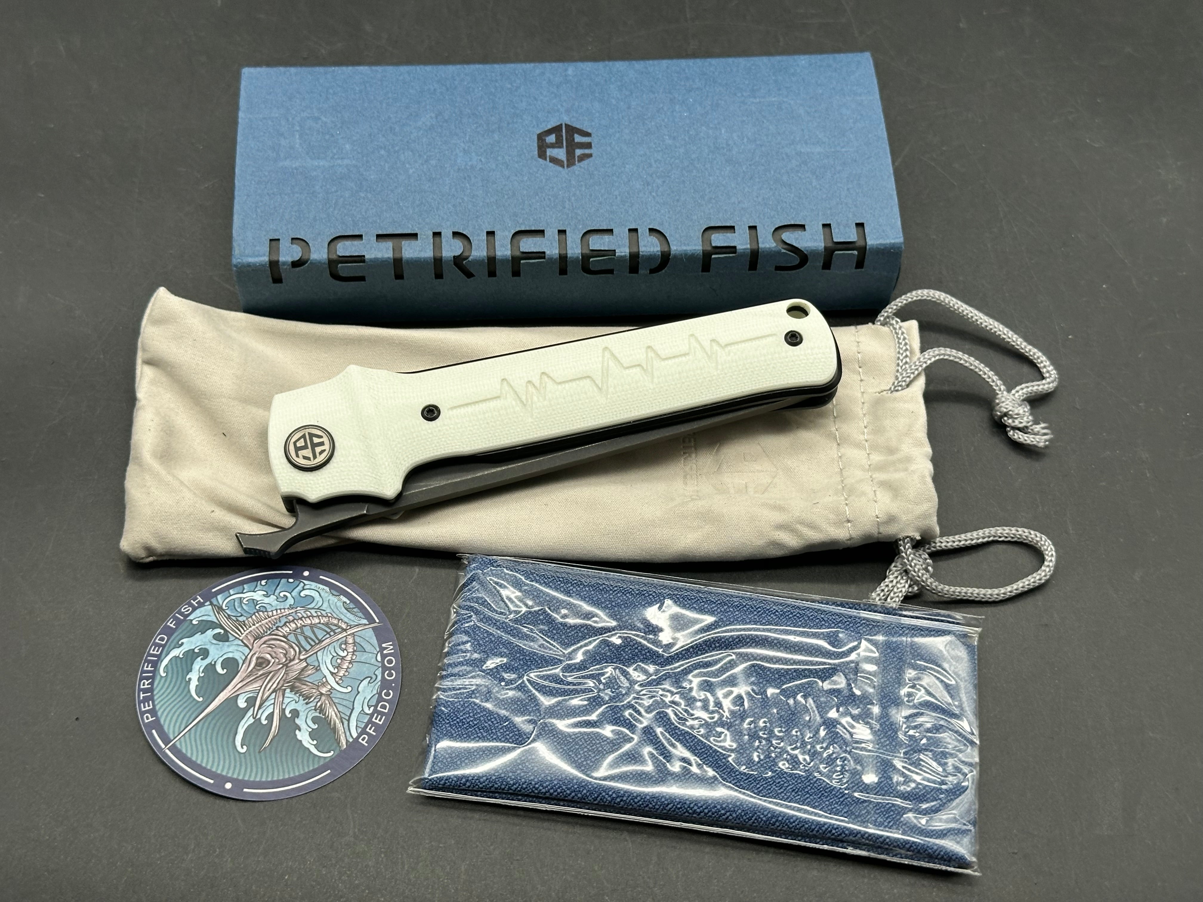 Petrified Fish Tena Folding Knife White G10 Handle D2 Plain Black Blade