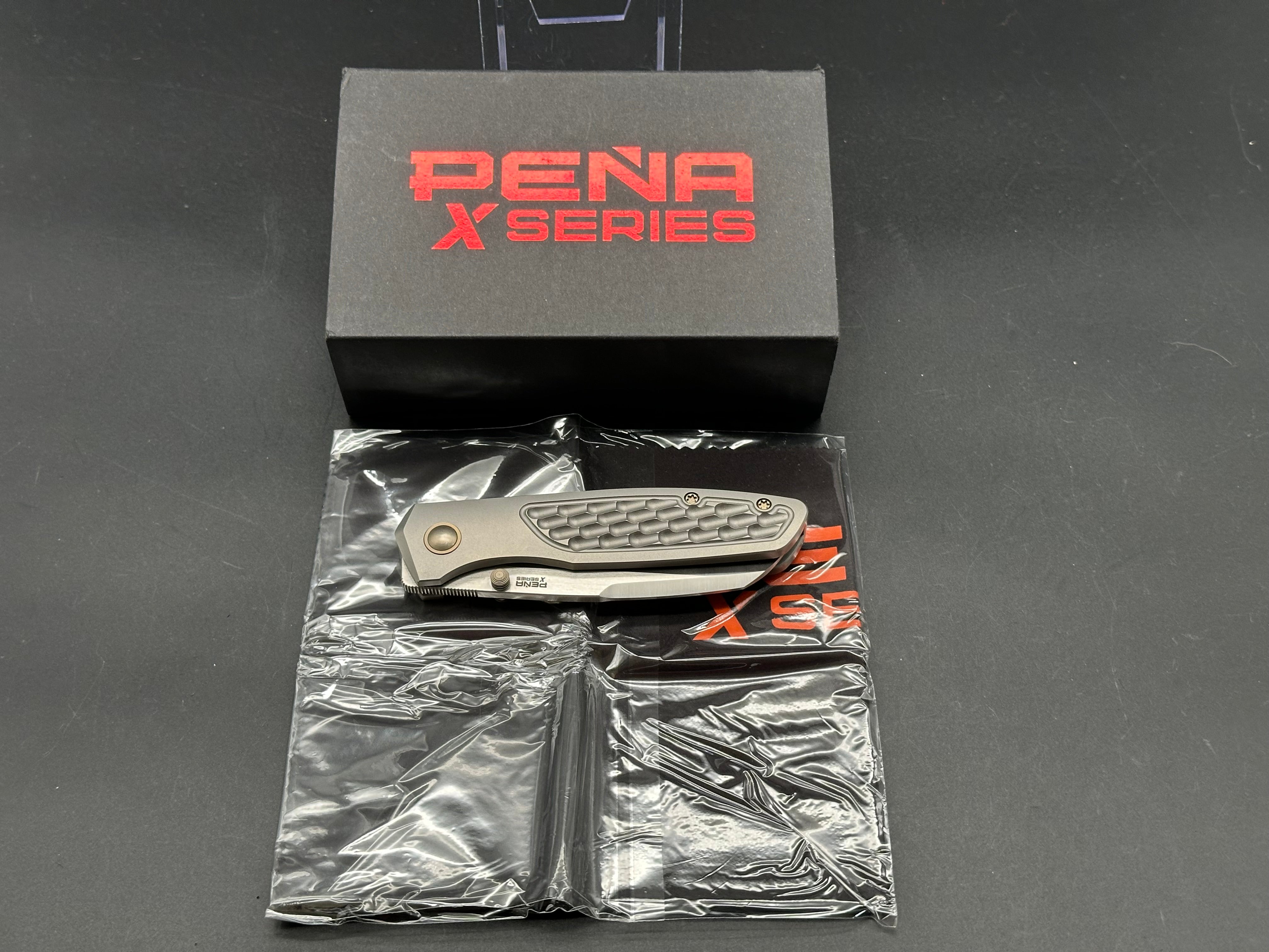Pena X-Series Bravo 1, Belt Satin M390 Blade, Jigged Titanium Handles