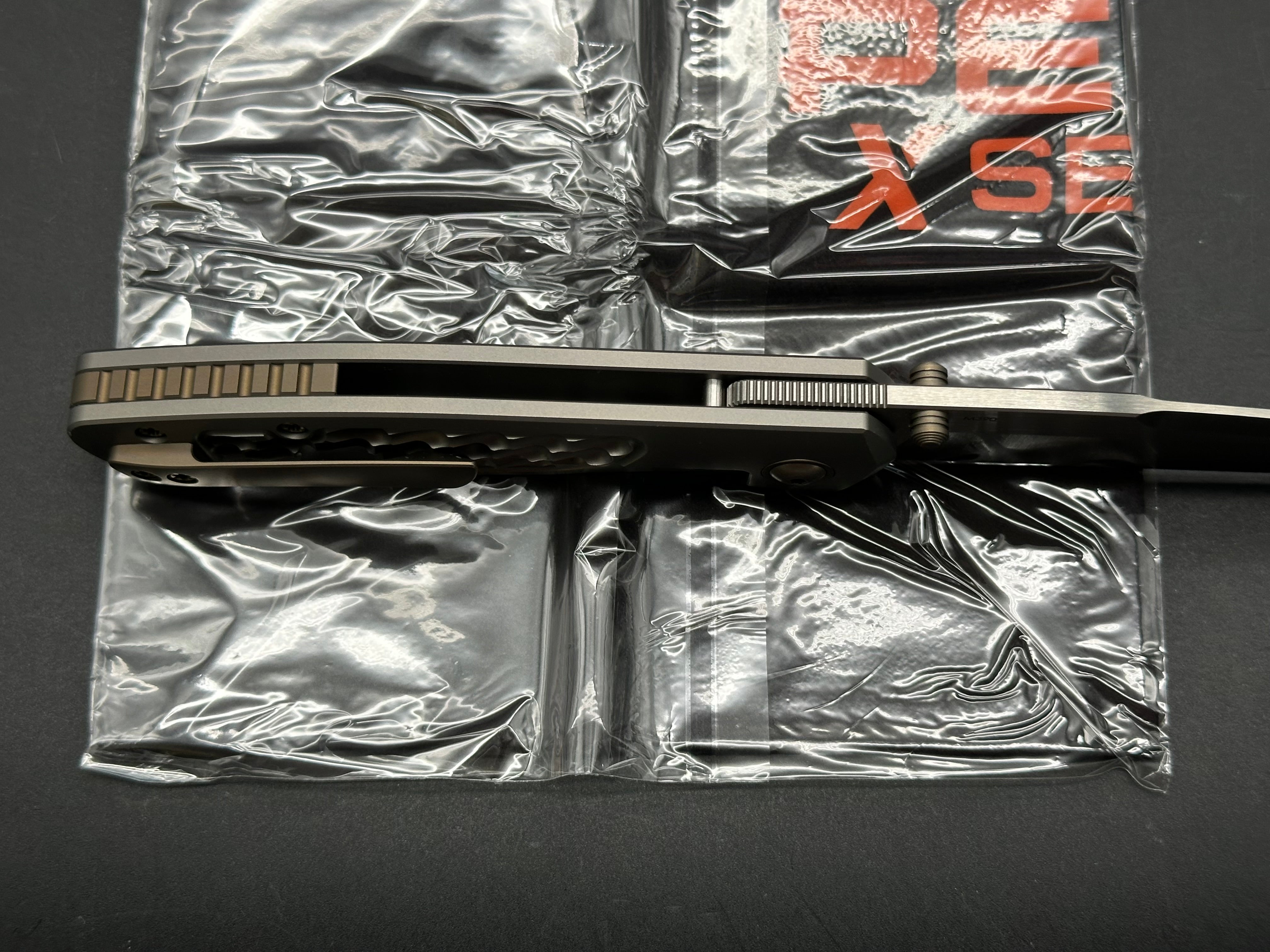 Pena X-Series Bravo 1, Belt Satin M390 Blade, Jigged Titanium Handles