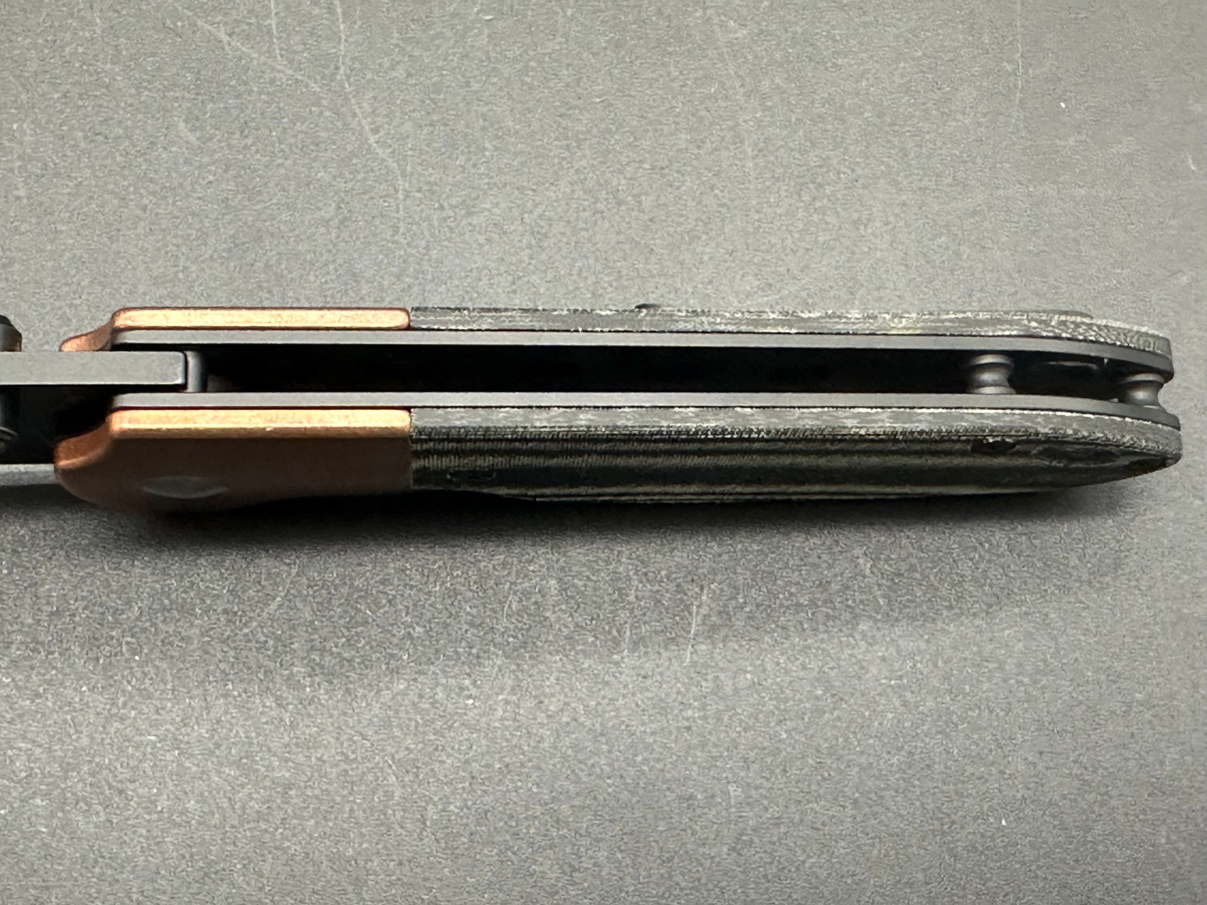 Kizer Deviant copper/micarta M390