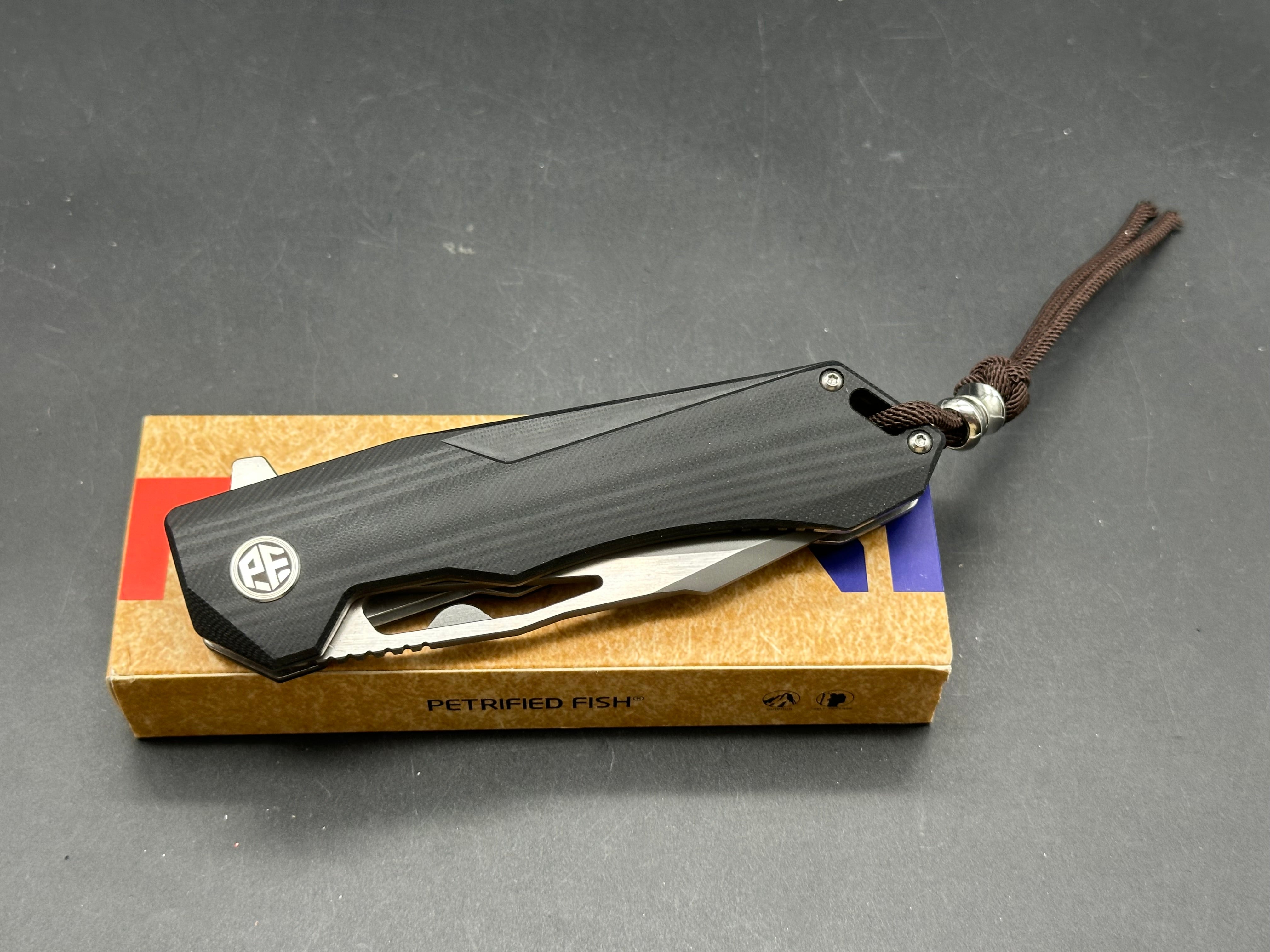 Petrified fish PF969 K110 steel blade G10 handle titanium alloy clip