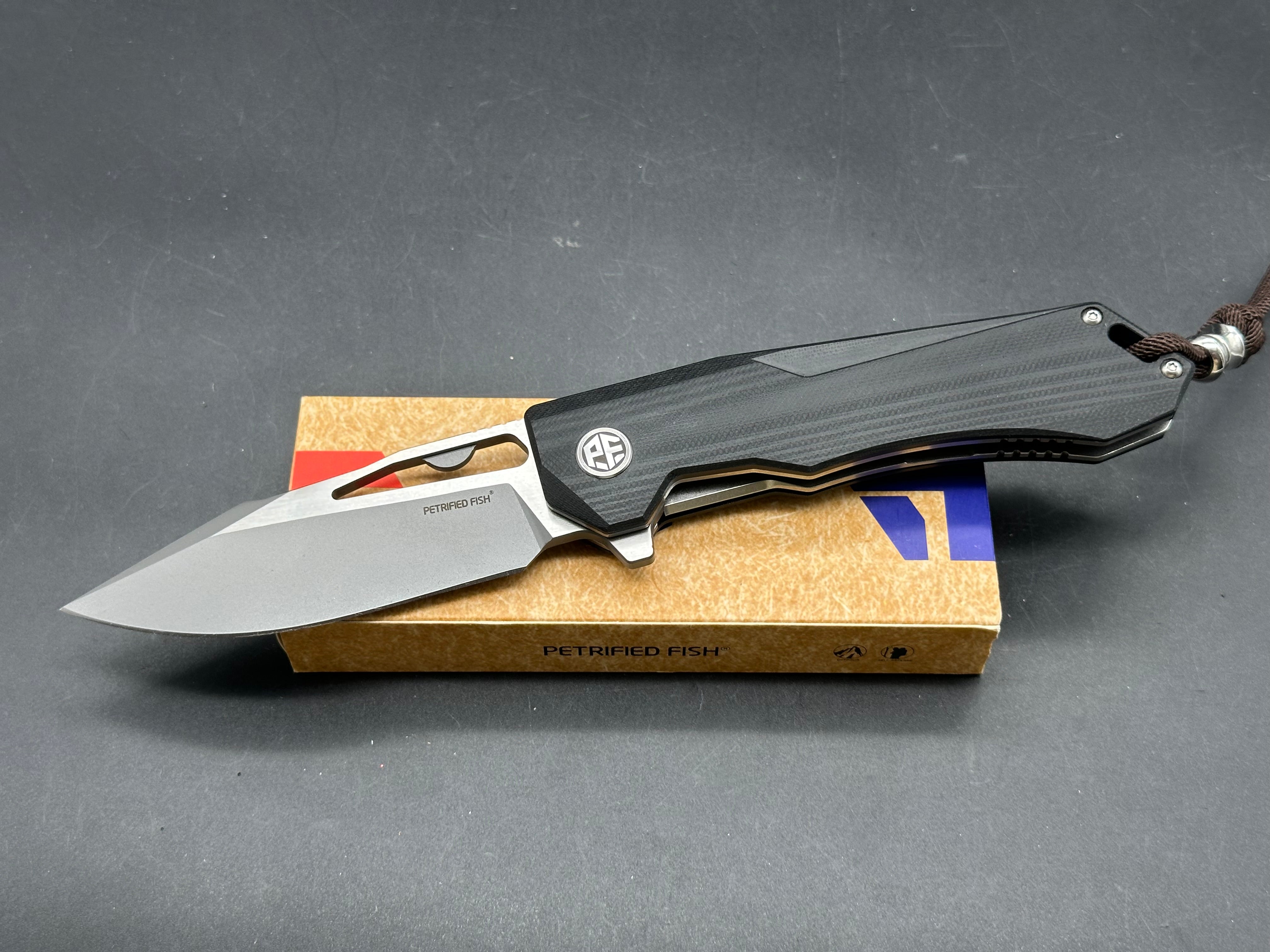 Petrified fish PF969 K110 steel blade G10 handle titanium alloy clip