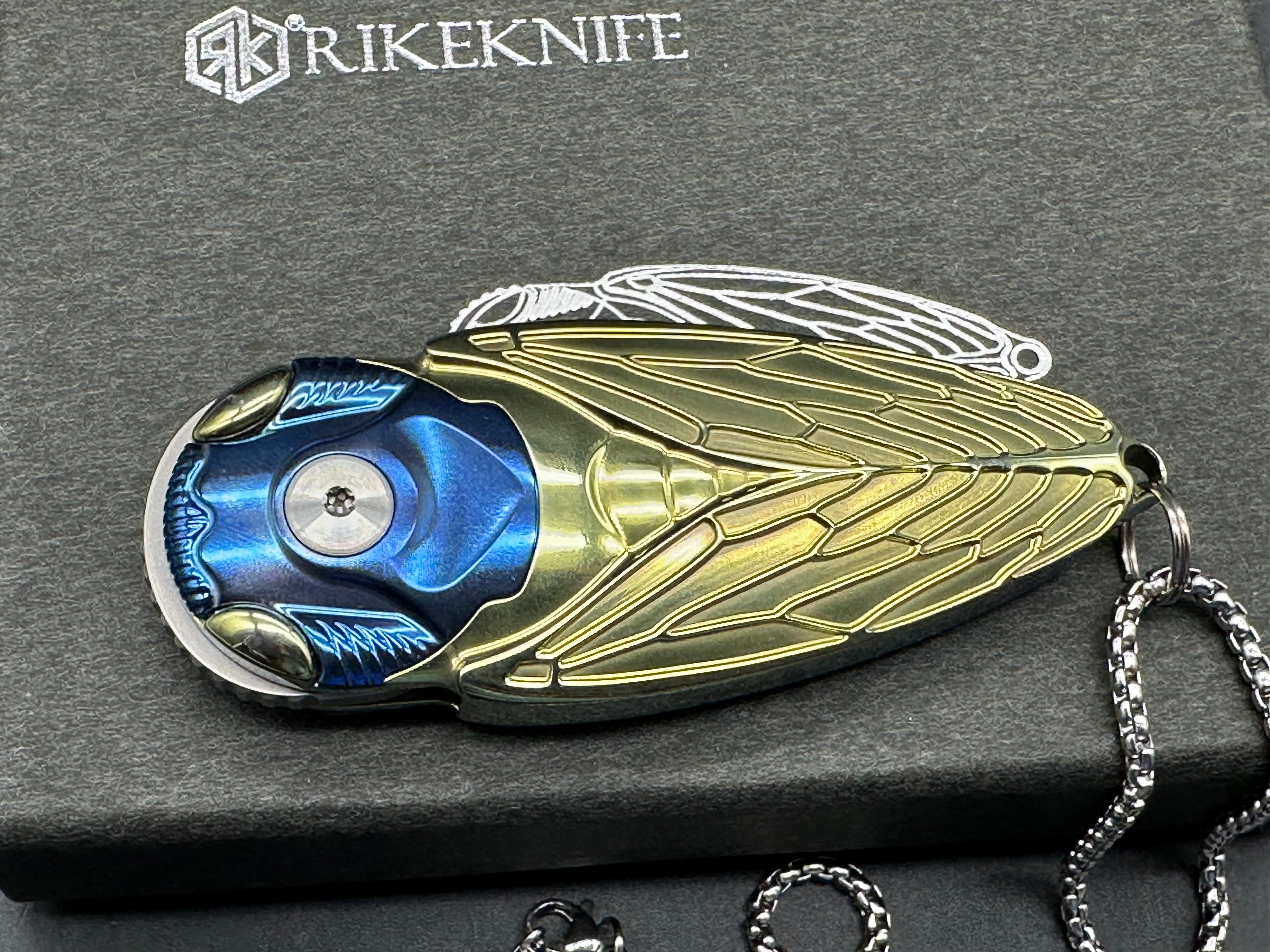Rike Knife - Cicada Blue & Gold M390 button lock
