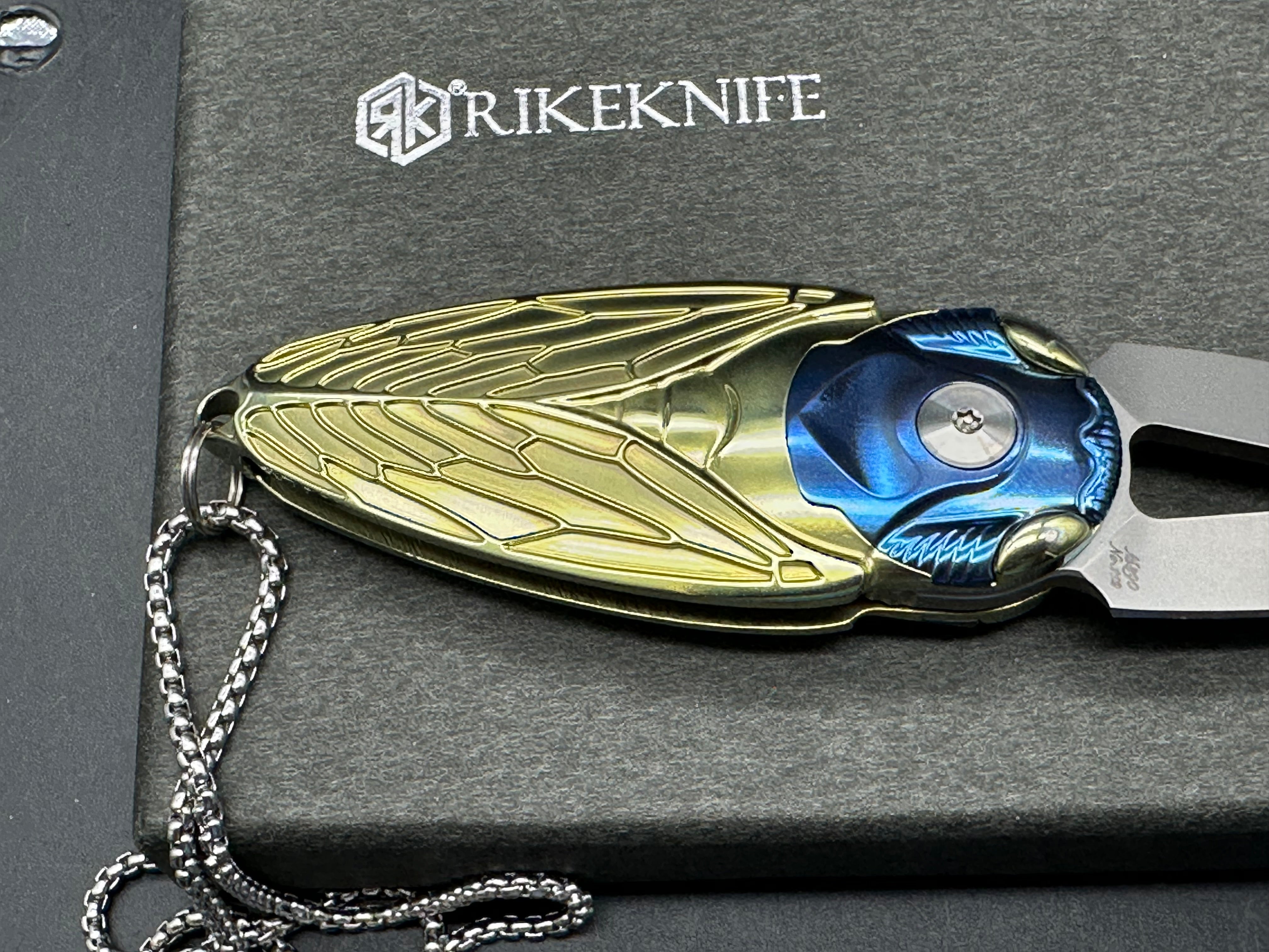 Rike Knife - Cicada Blue & Gold M390 button lock