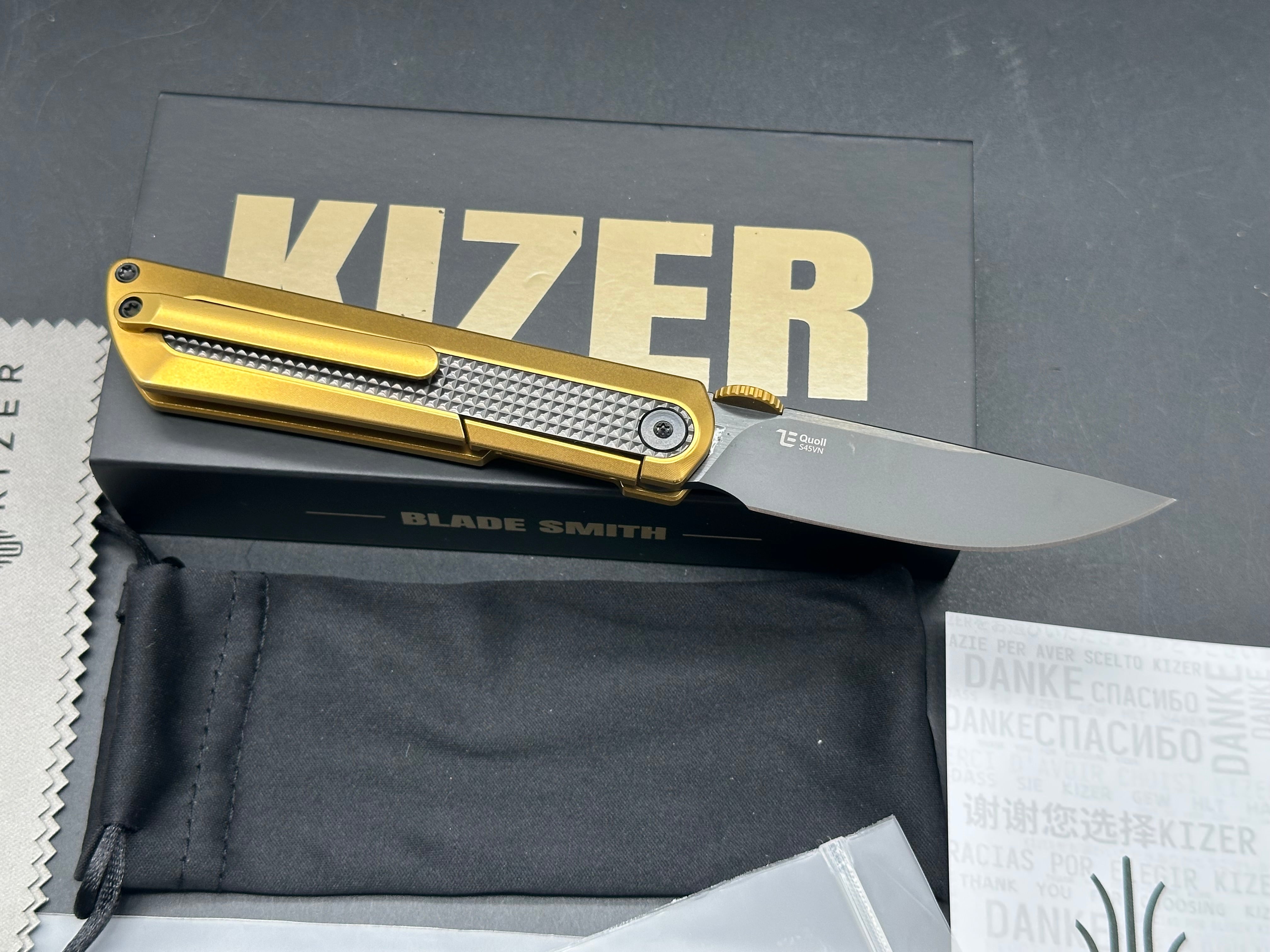 KIZER QUOLL GOLD/BLACK TITANIUM/ZIRCONIUM HANDLE S45VN DROP POINT PLAIN BLACK BLADE
