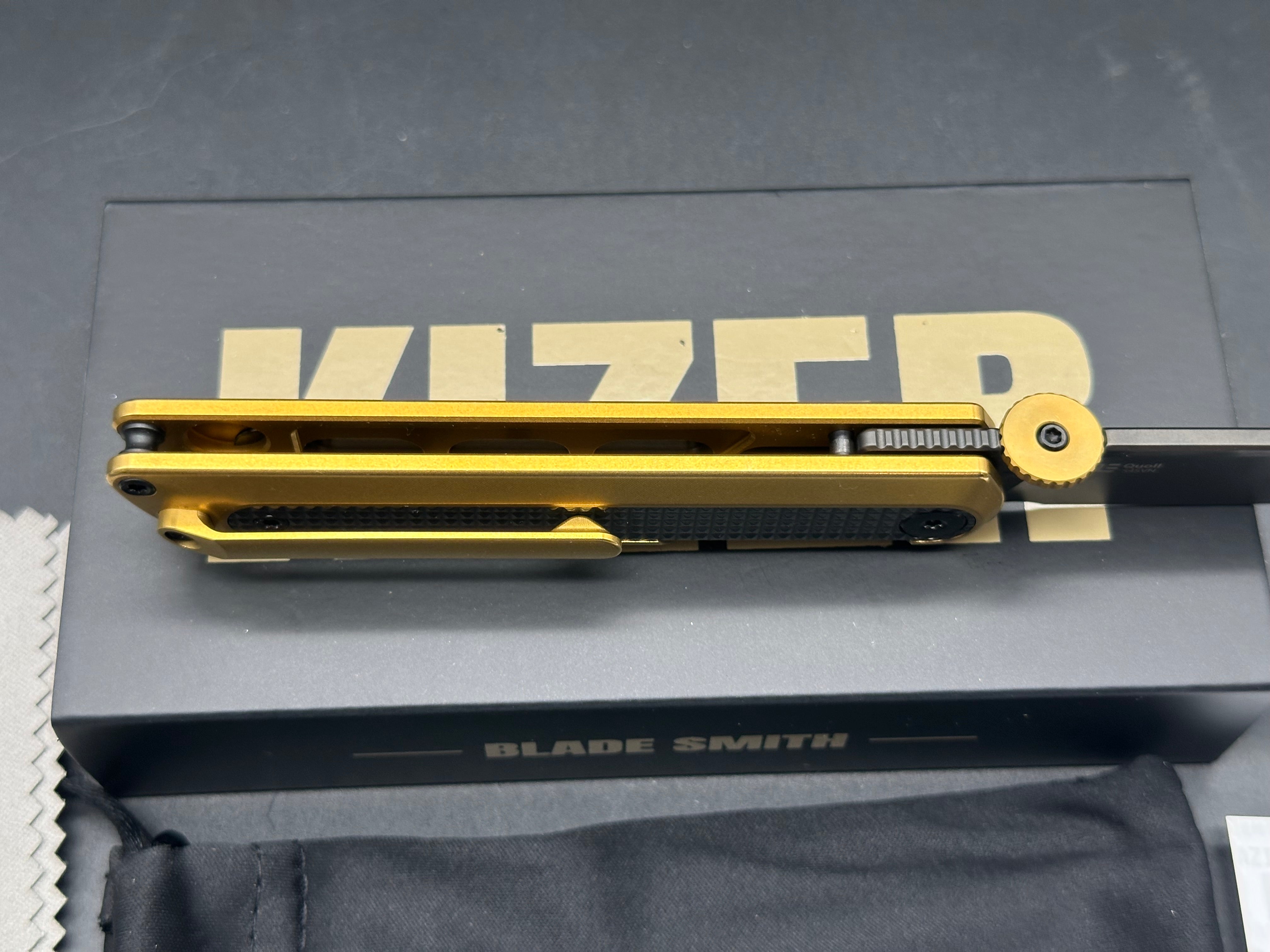 KIZER QUOLL GOLD/BLACK TITANIUM/ZIRCONIUM HANDLE S45VN DROP POINT PLAIN BLACK BLADE