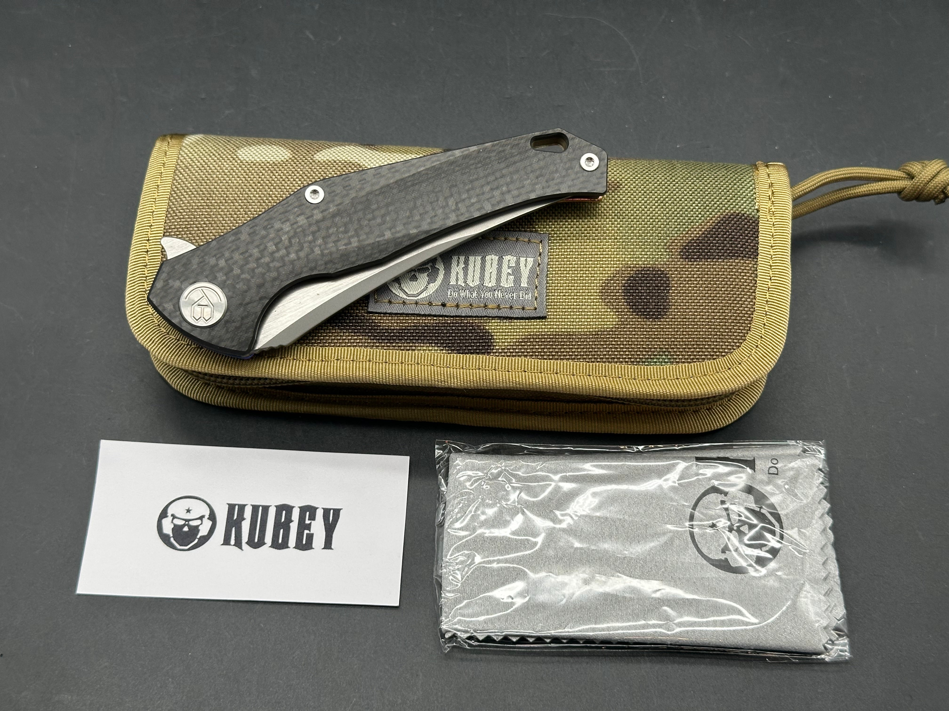 Kubey Caiman colored titanium frame with Carbon Fiber scale