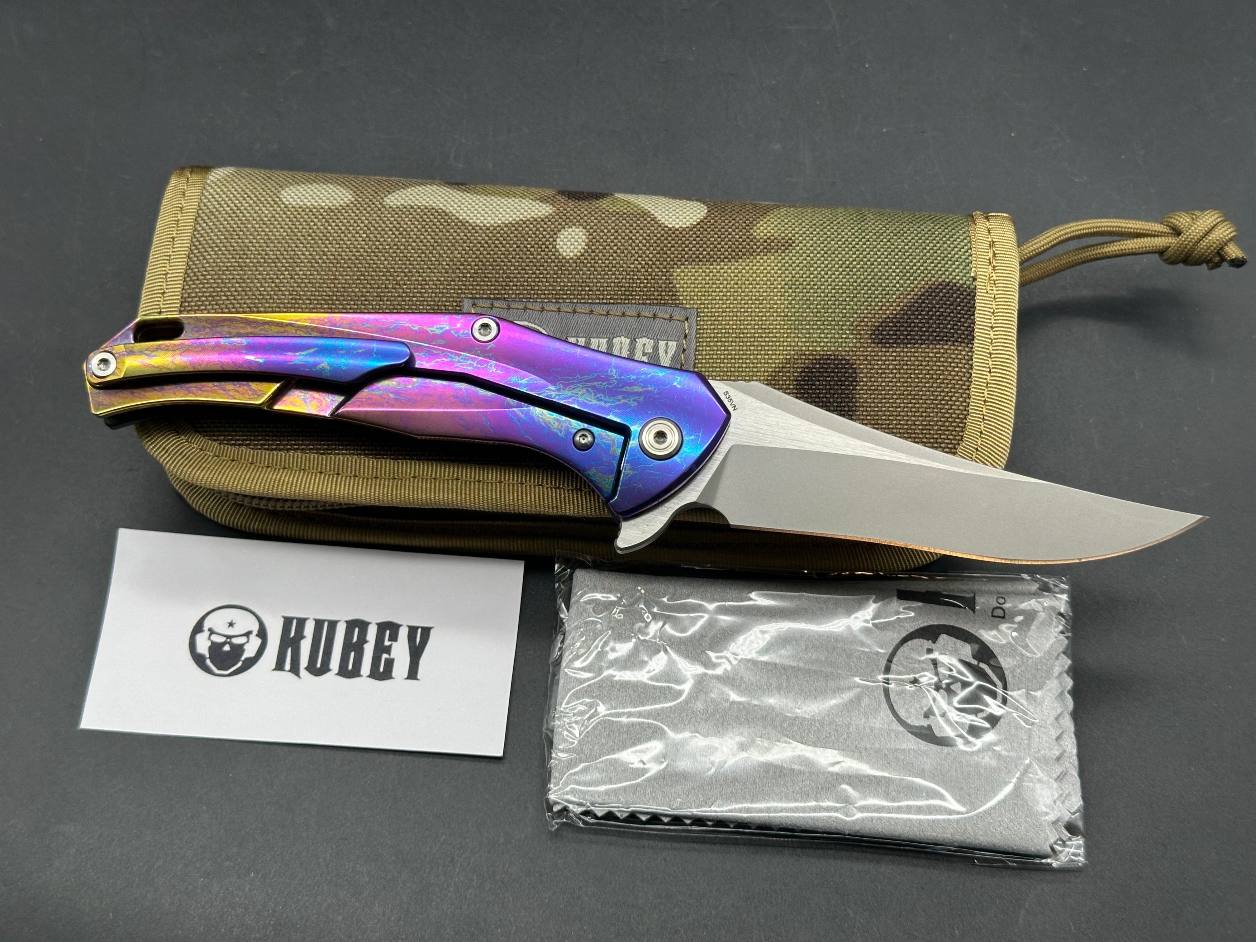 Kubey Caiman colored titanium frame with Carbon Fiber scale