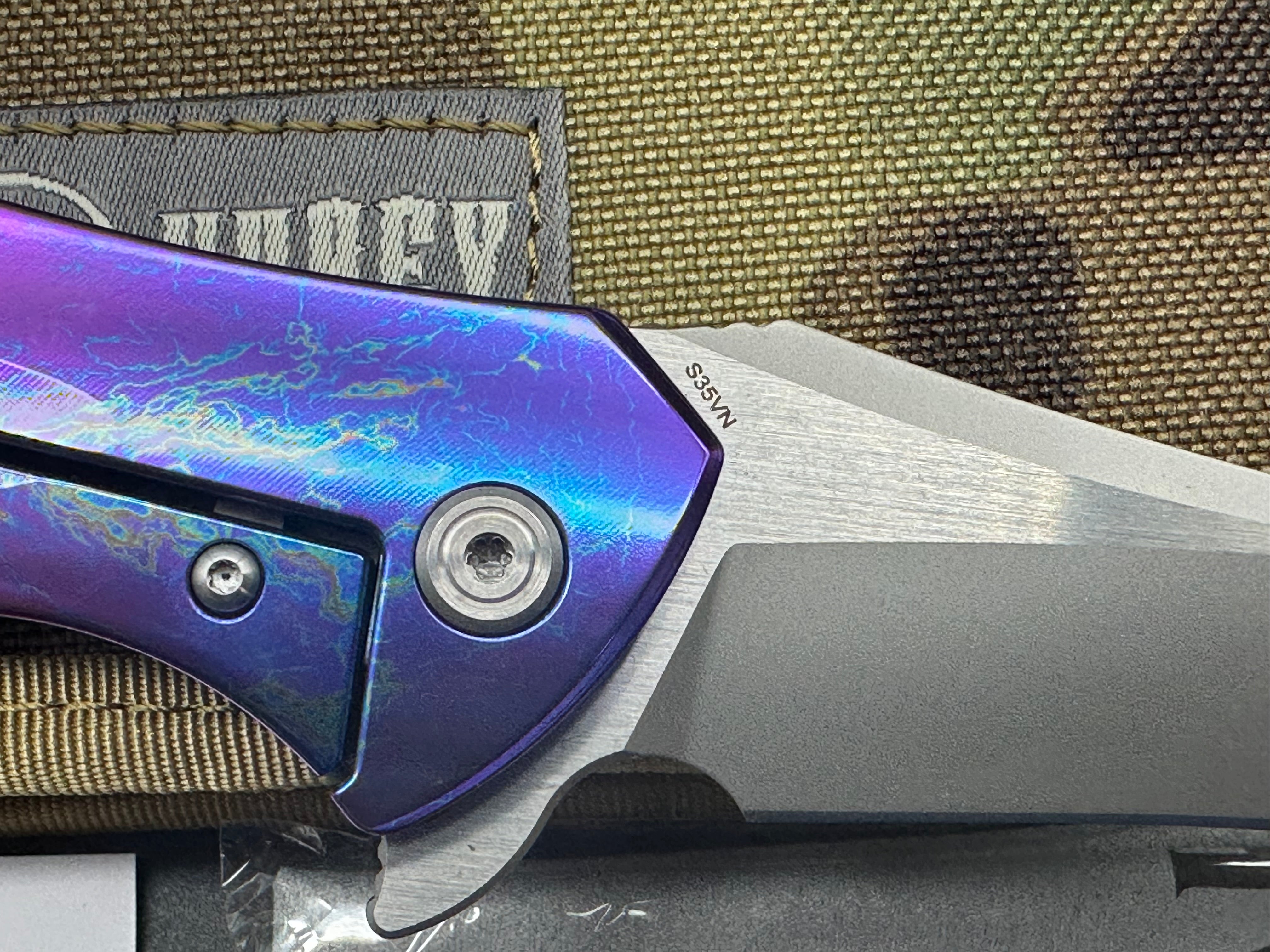 Kubey Caiman colored titanium frame with Carbon Fiber scale