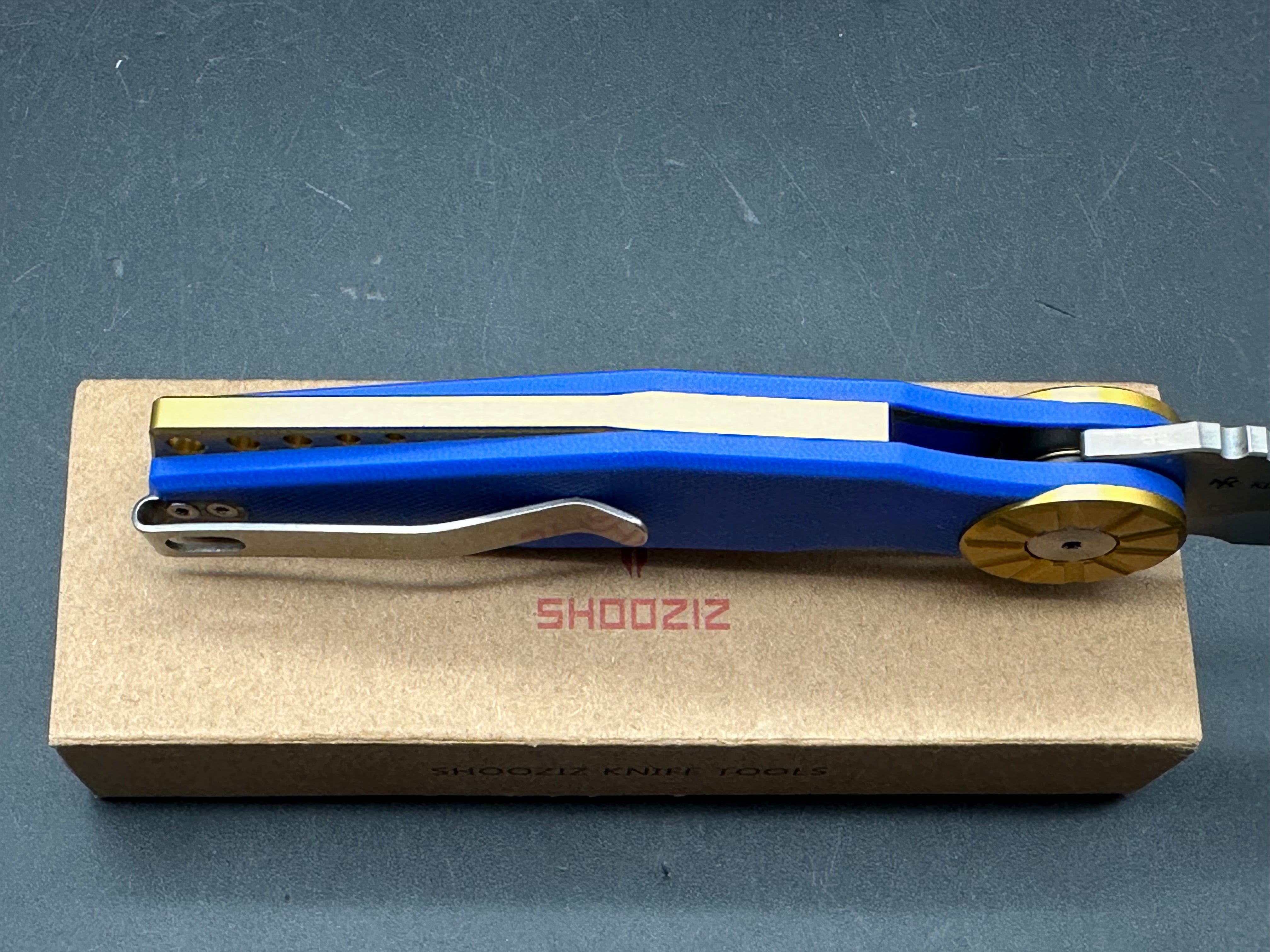 Shooziz Kila DC53 Steel, Aluminum Bolster, Blue G10 Handle