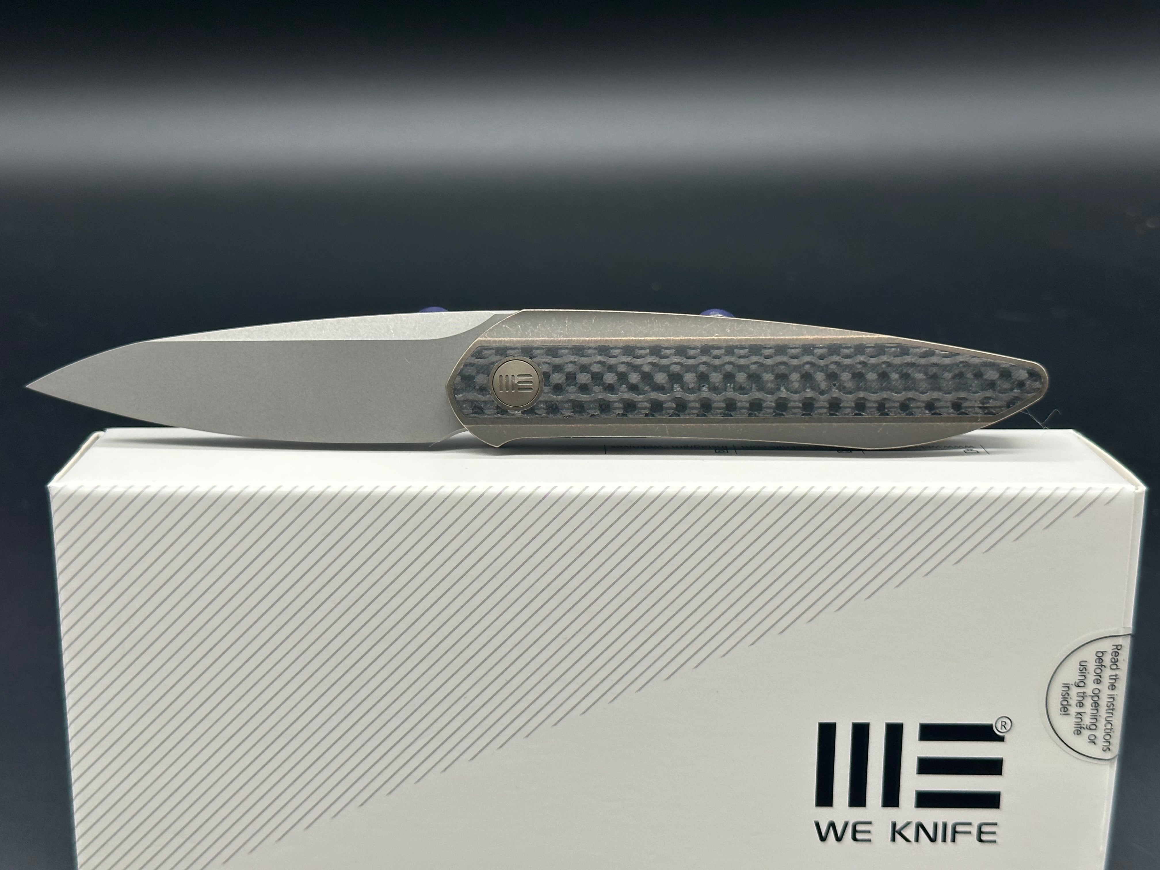 WE Black Void Opus Bronze Handle with twill carbon fiber inlay CPM 20CV