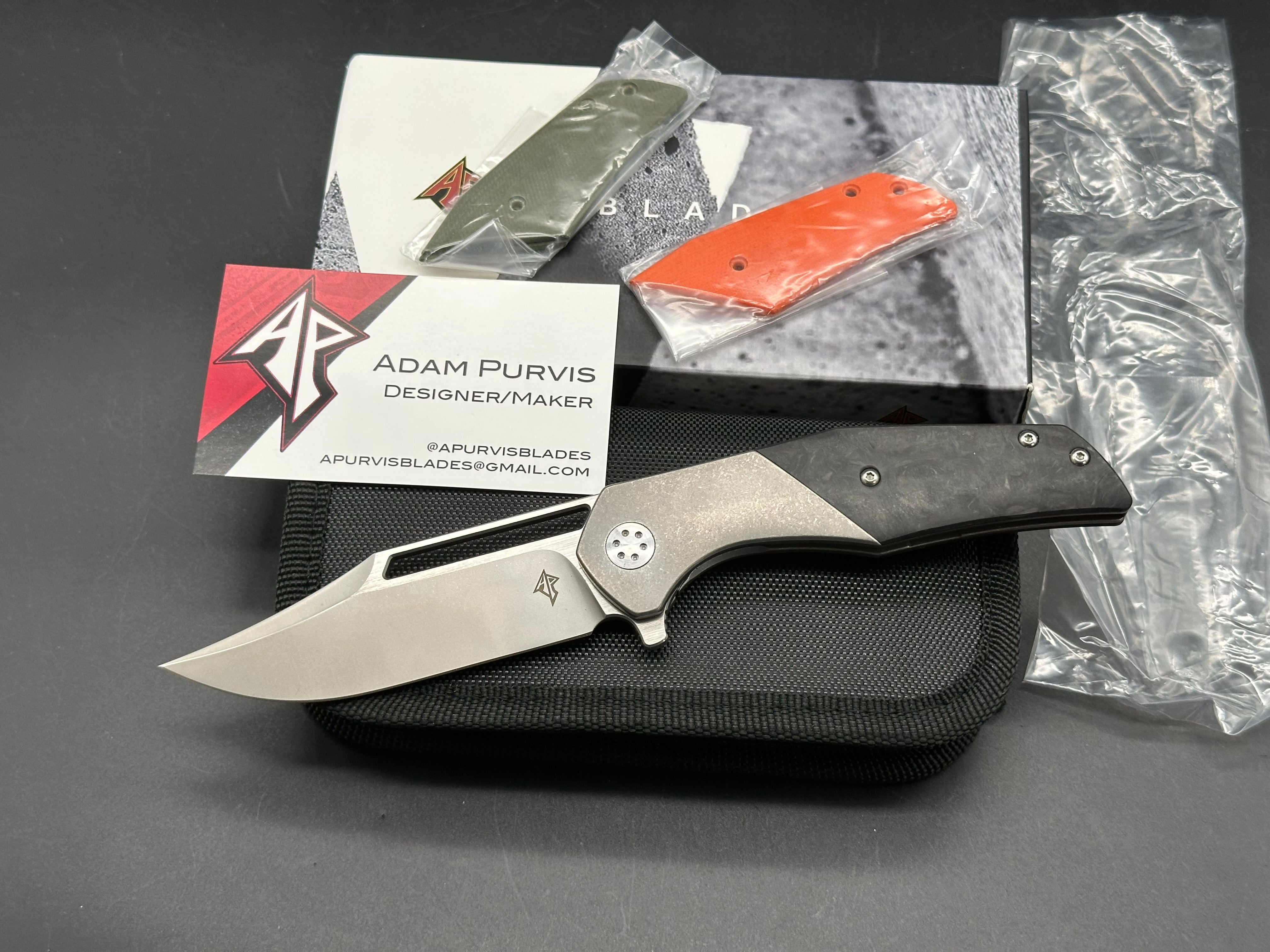 A. Purvis Blades Primordial MK2, Stonewashed M390 Blade Titanium Handles with Marbled Carbon Fiber Overlays