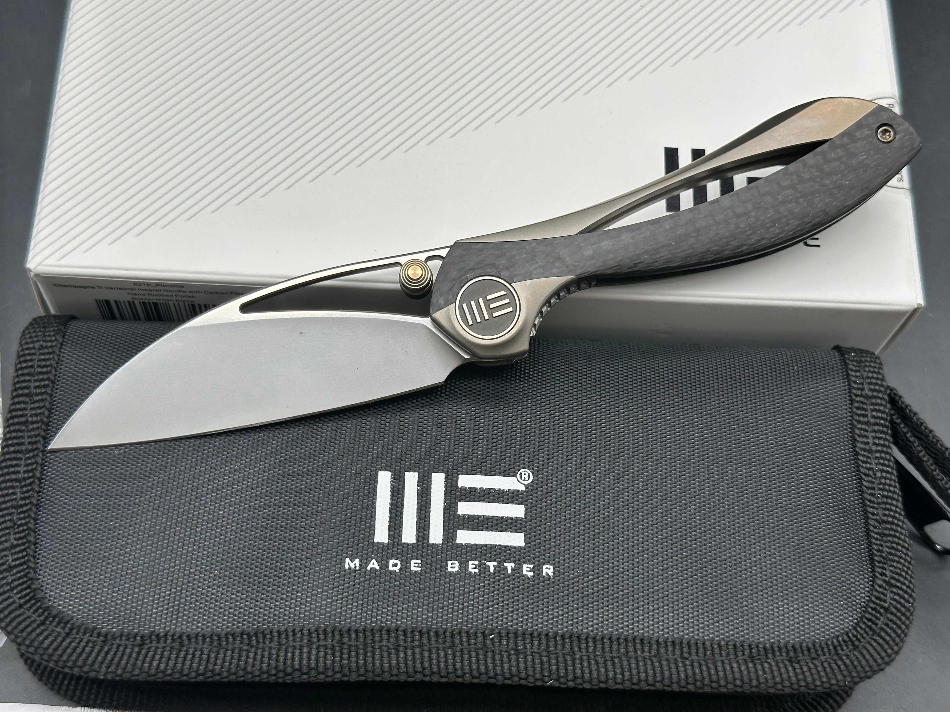 We Pleroma: Elijah Isham design. 2.95 inch M390 Carbon fiber and integral champagne titanium handle