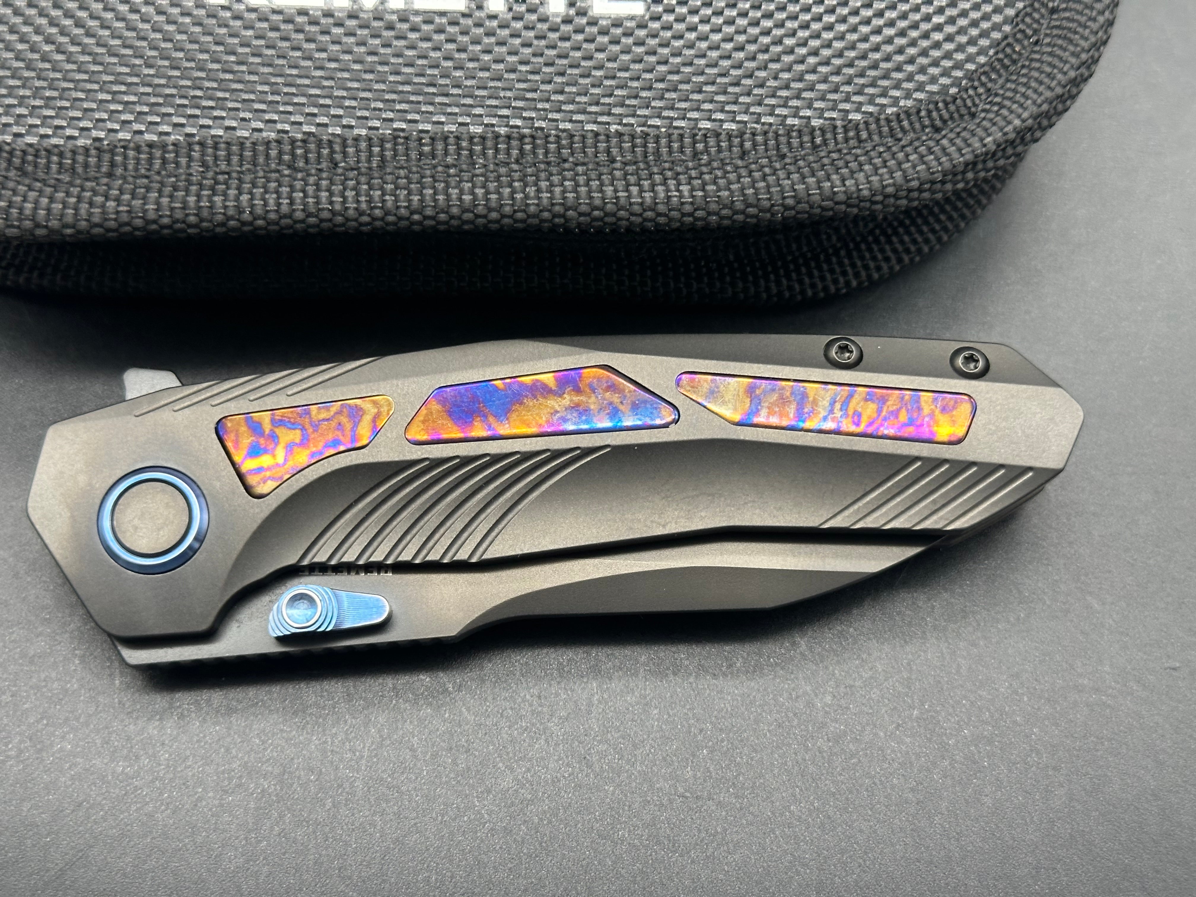 Remette RT-Kestrel with DLC titanium scales with Timascus inlay and clip. DLC S35vn blade