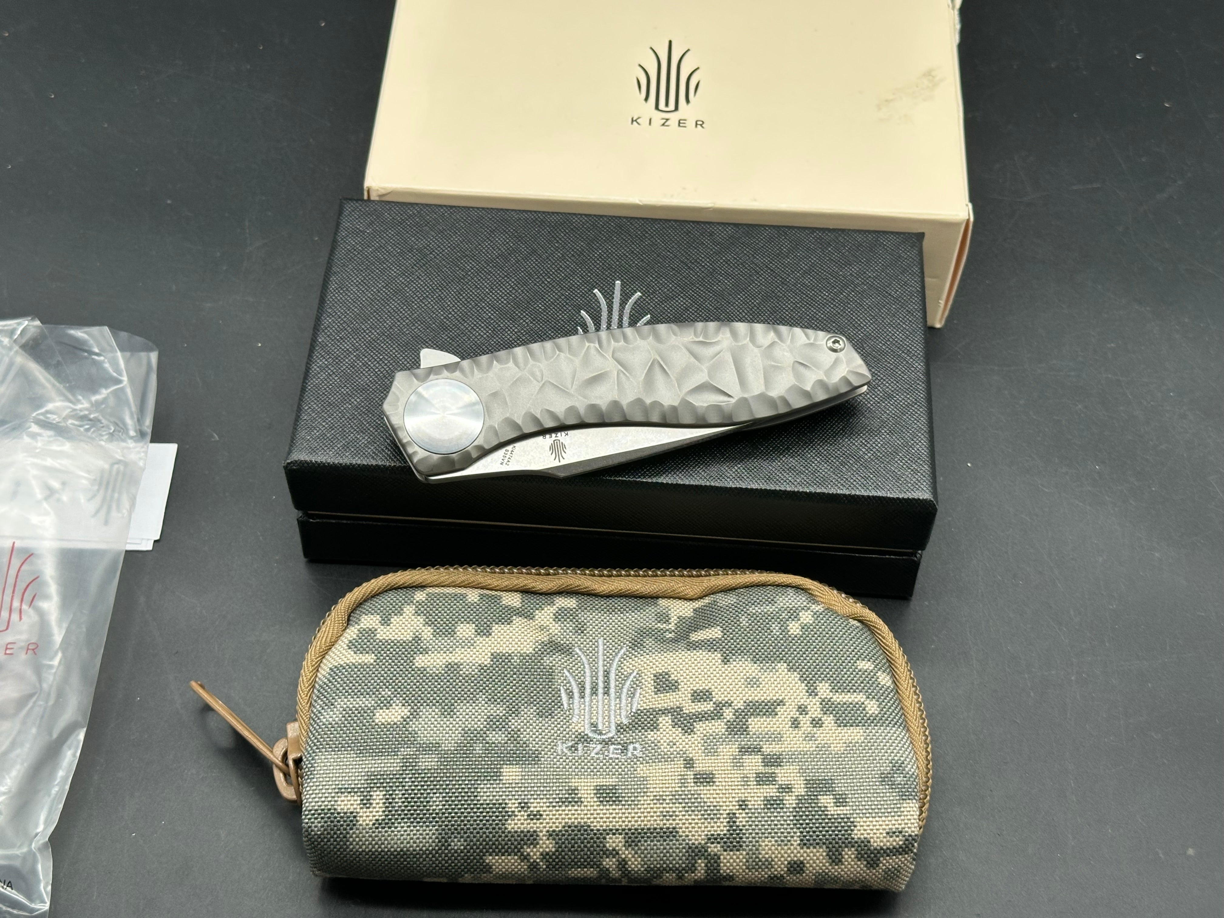 Kizer S.L.T.: John Gray design. 3.5 inch, hollow grind CPM-S35V blade. Frame lock. Titanium handle
