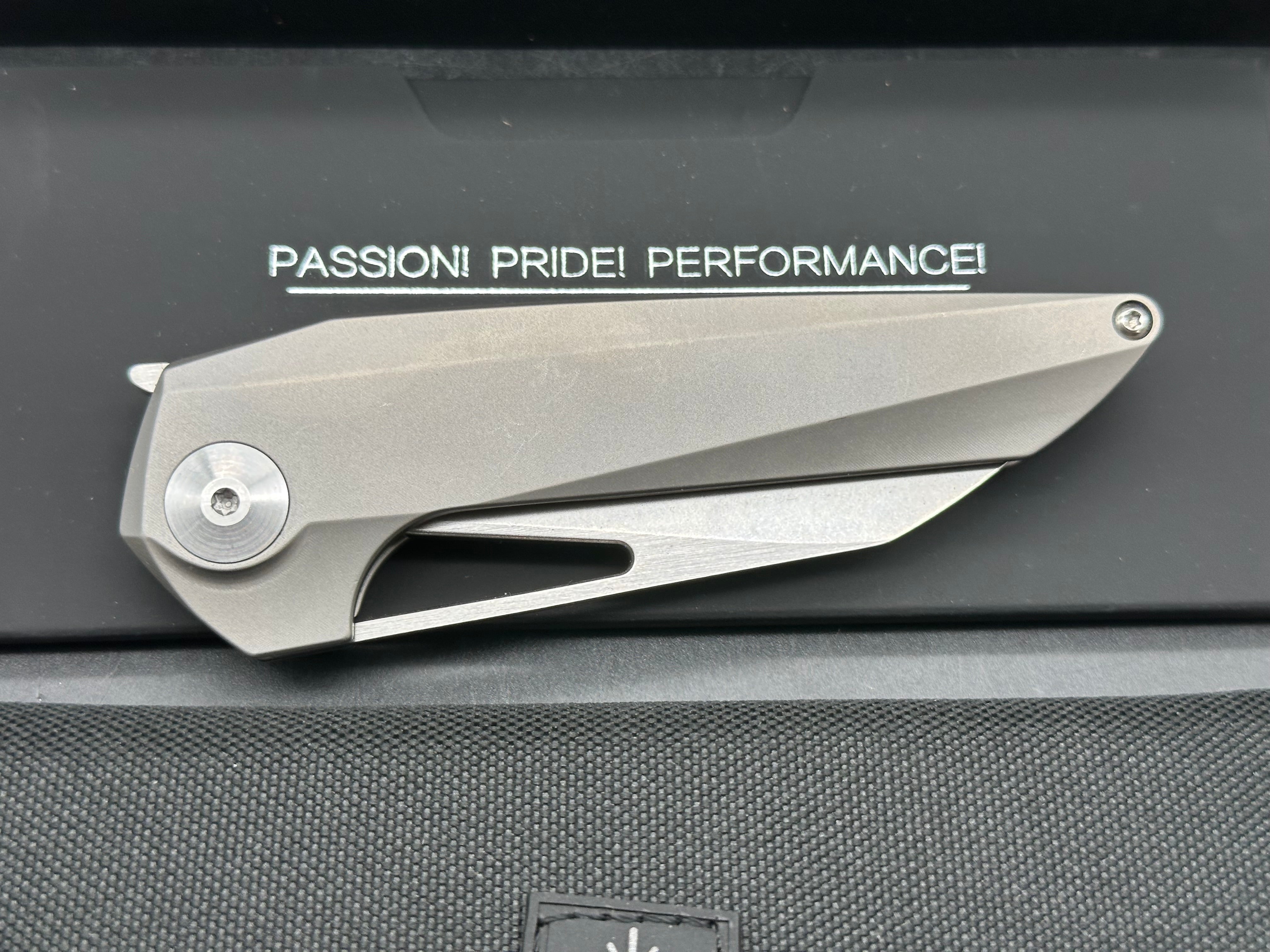 Kizer Theta: Elijah Isham design. 3.125 inch, stonewashed, flat grind, Wharncliffe CMP-S35V blade. Titanium handle