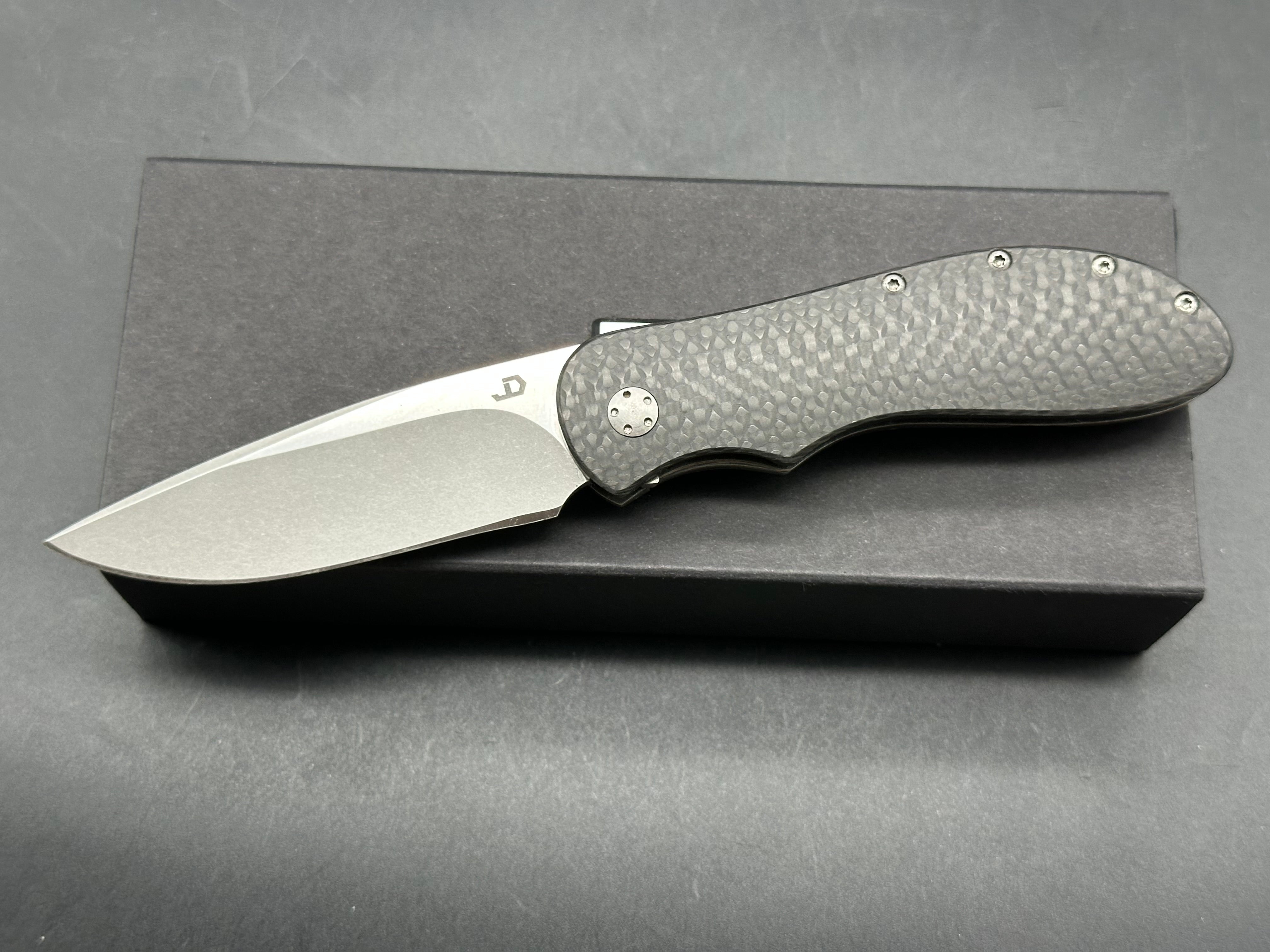 JD Van Deventer EDC Front Flipper 2.75 inch drop point, stone washed two tone N690 blade. Acid tumble titanium frame with carbon fiber handle