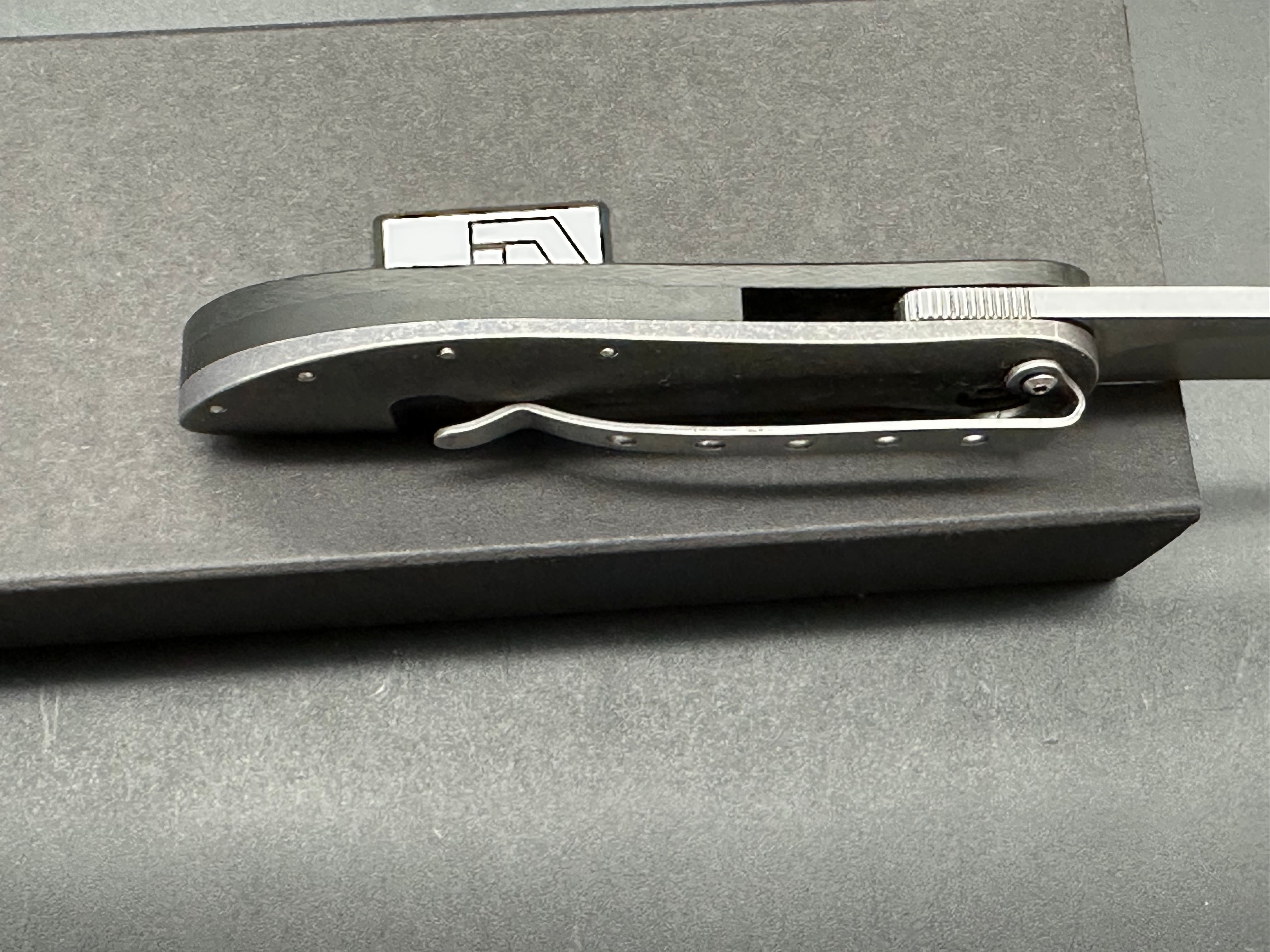 JD Van Deventer EDC Front Flipper 2.75 inch drop point, stone washed two tone N690 blade. Acid tumble titanium frame with carbon fiber handle