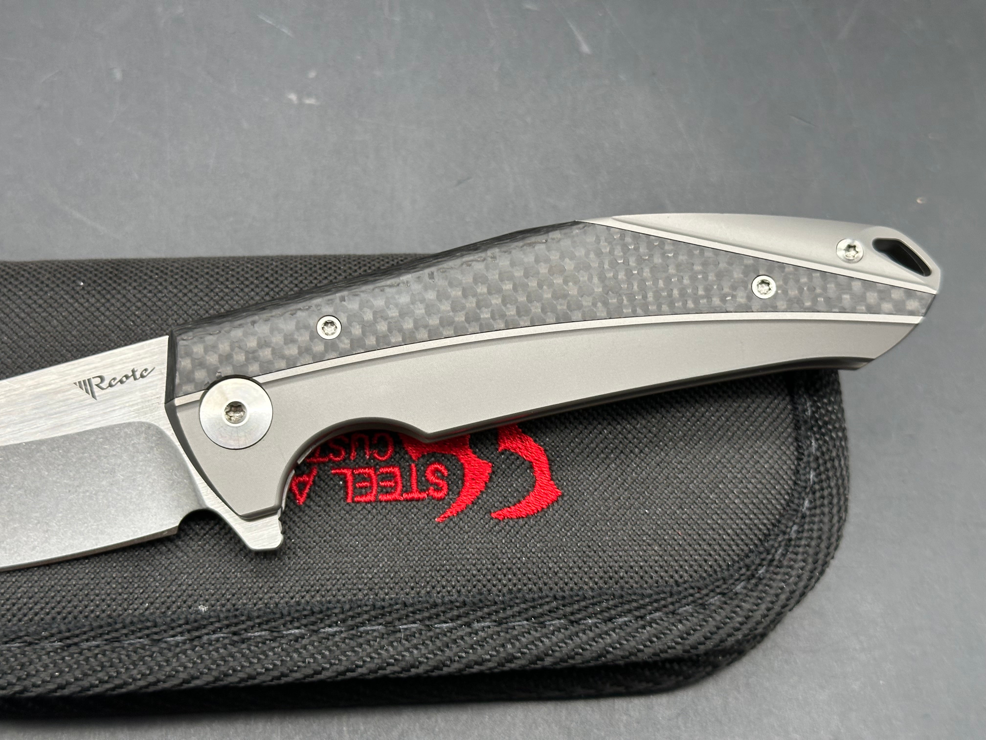Reate K1: 3.875 inch RWL-34 blade. Steel overtravel stop. Titanium and carbon fiber handle