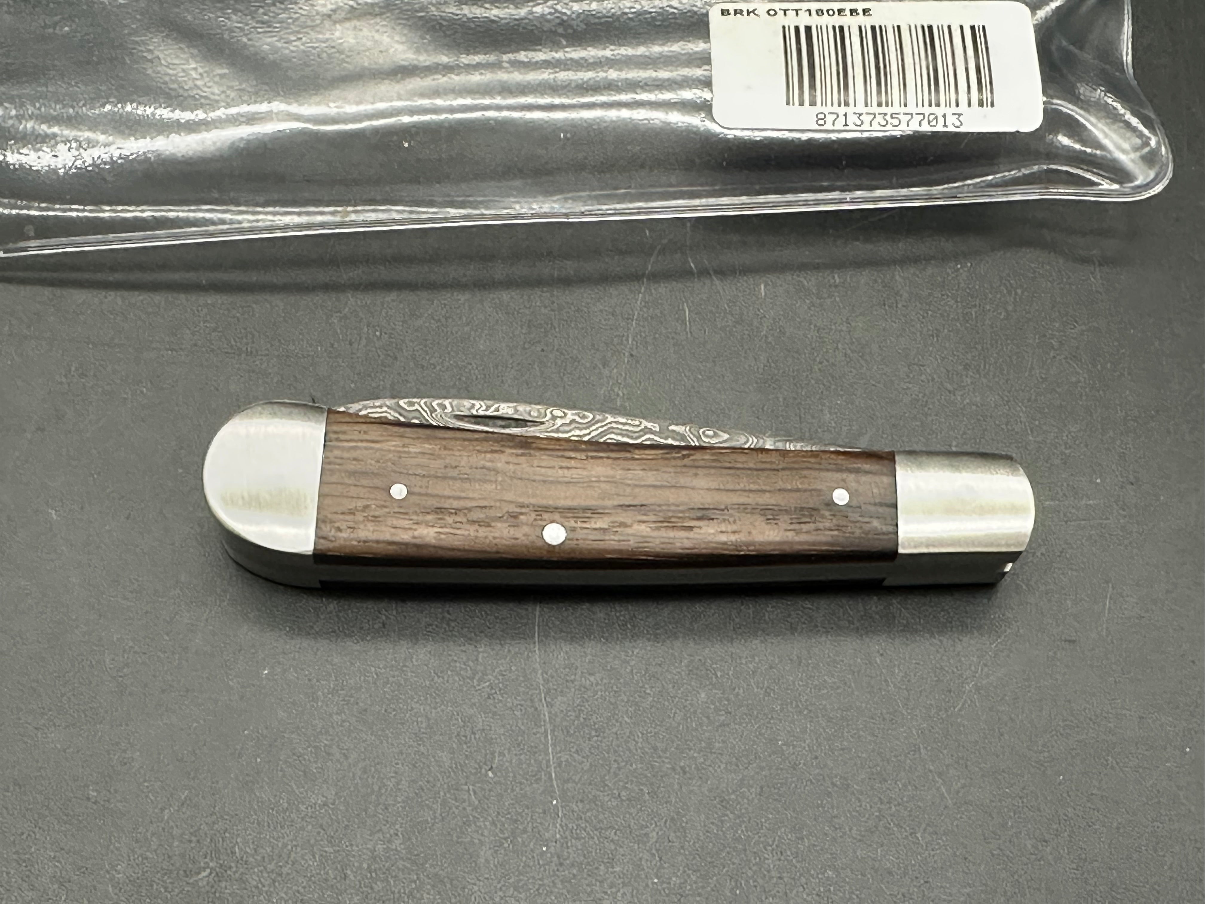 Otter Messer slipjoint with Damascus. Oak covers. 2.95 inch blade