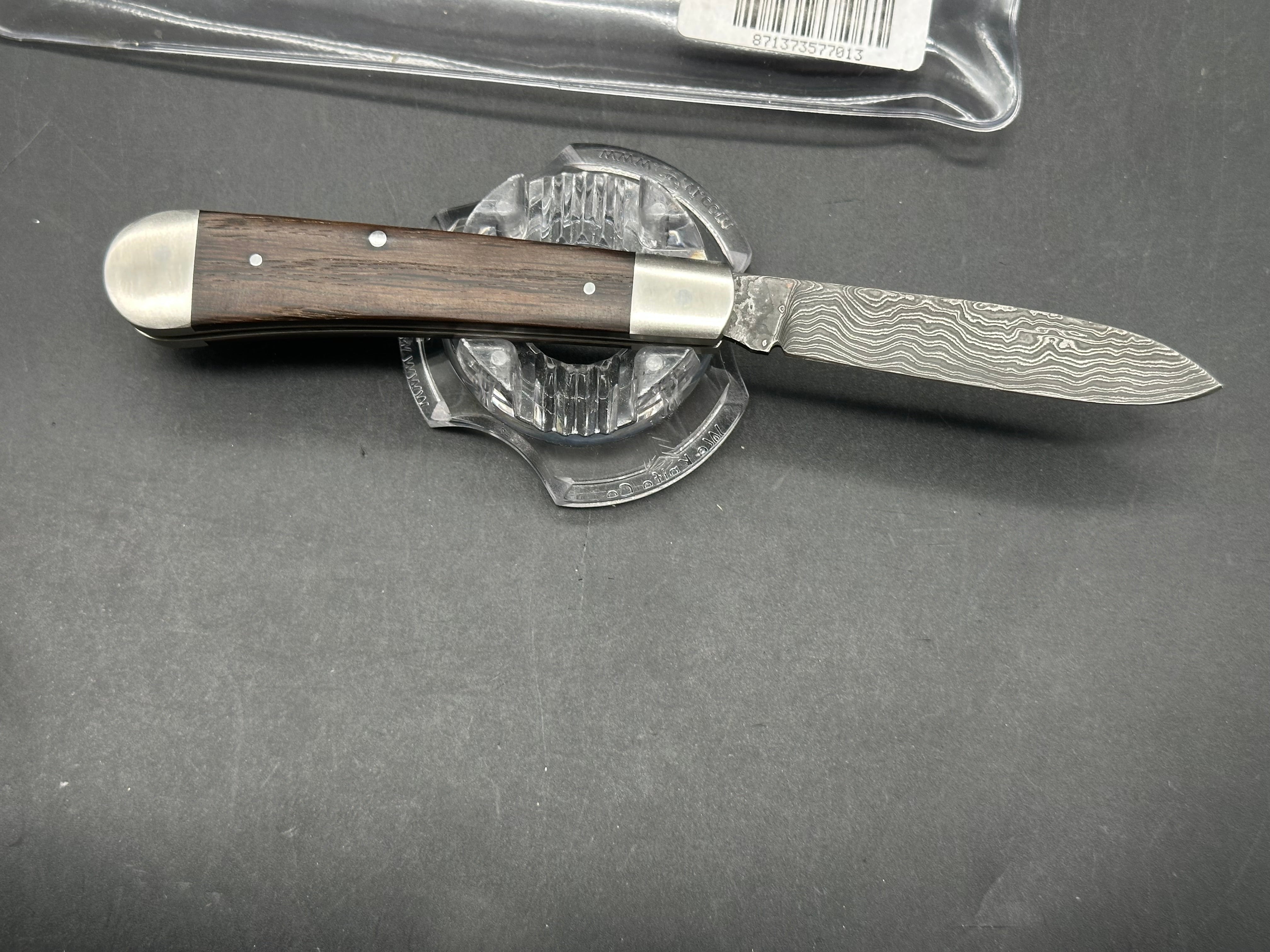 Otter Messer slipjoint with Damascus. Oak covers. 2.95 inch blade
