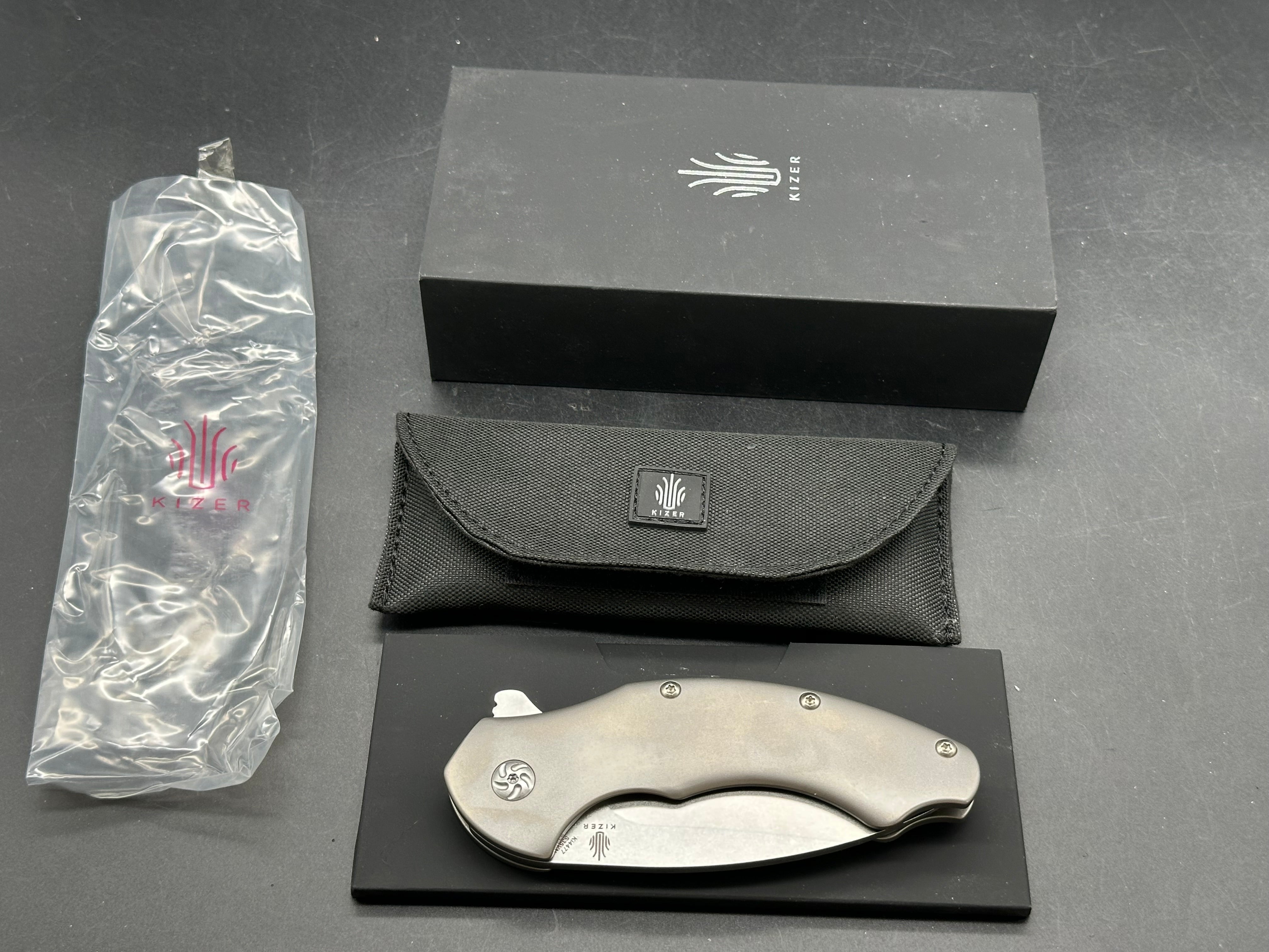 Kizer Roach Matt Degnan design 3.5 inch drop point flat grind, satin CPM-S35VN blade Titanium scales and clip with Roach insignia