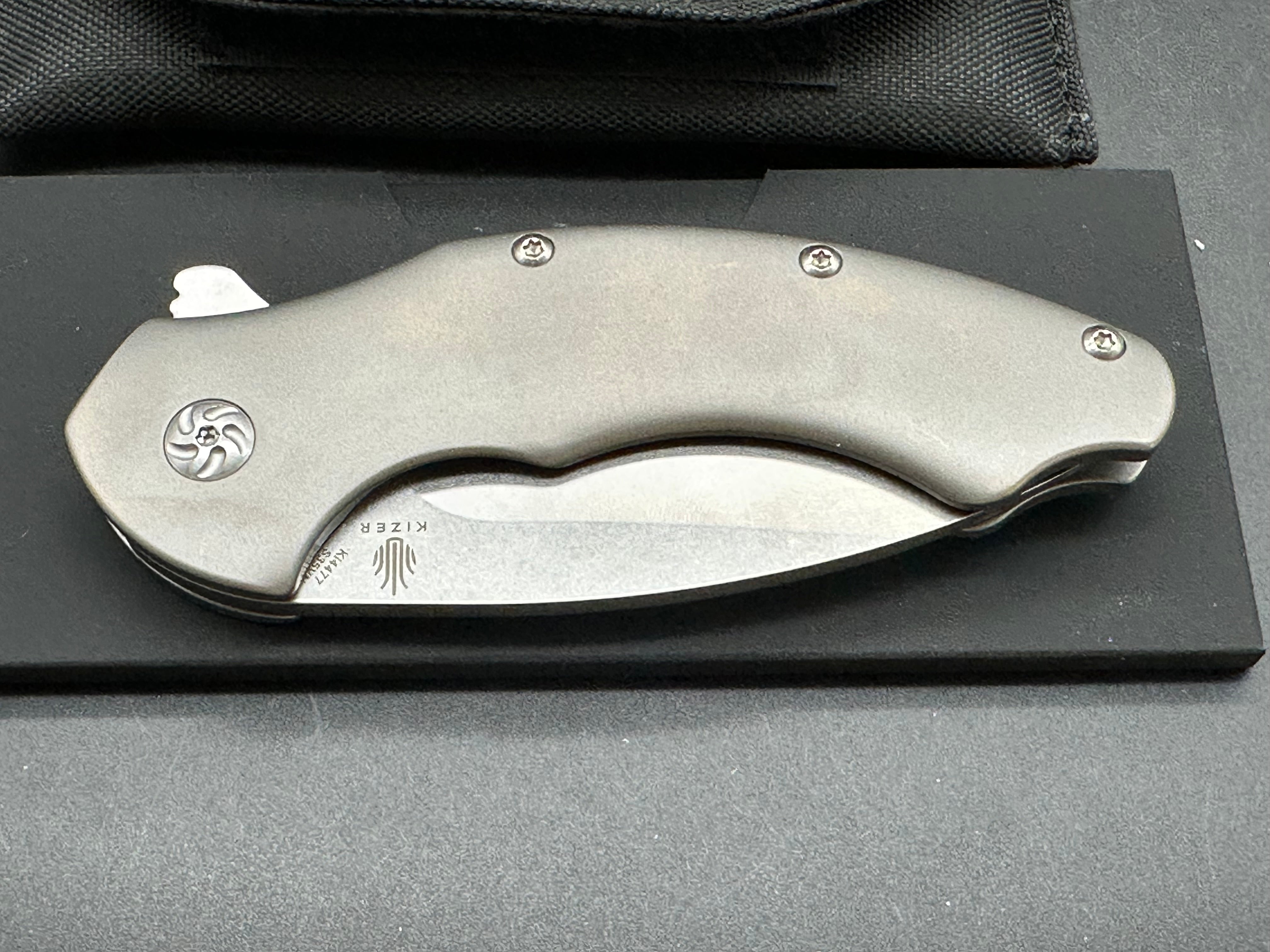 Kizer Roach Matt Degnan design 3.5 inch drop point flat grind, satin CPM-S35VN blade Titanium scales and clip with Roach insignia