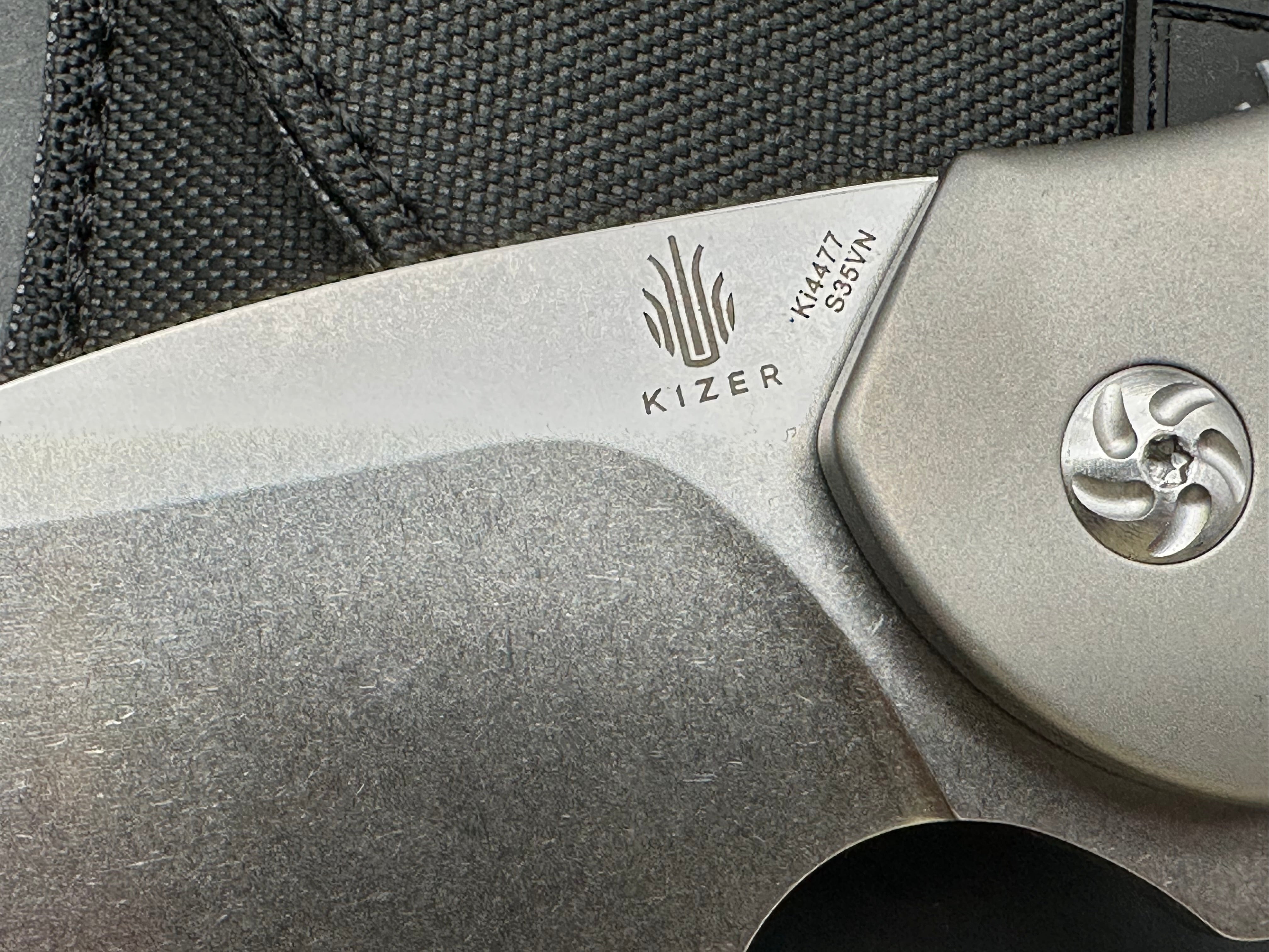 Kizer Roach Matt Degnan design 3.5 inch drop point flat grind, satin CPM-S35VN blade Titanium scales and clip with Roach insignia