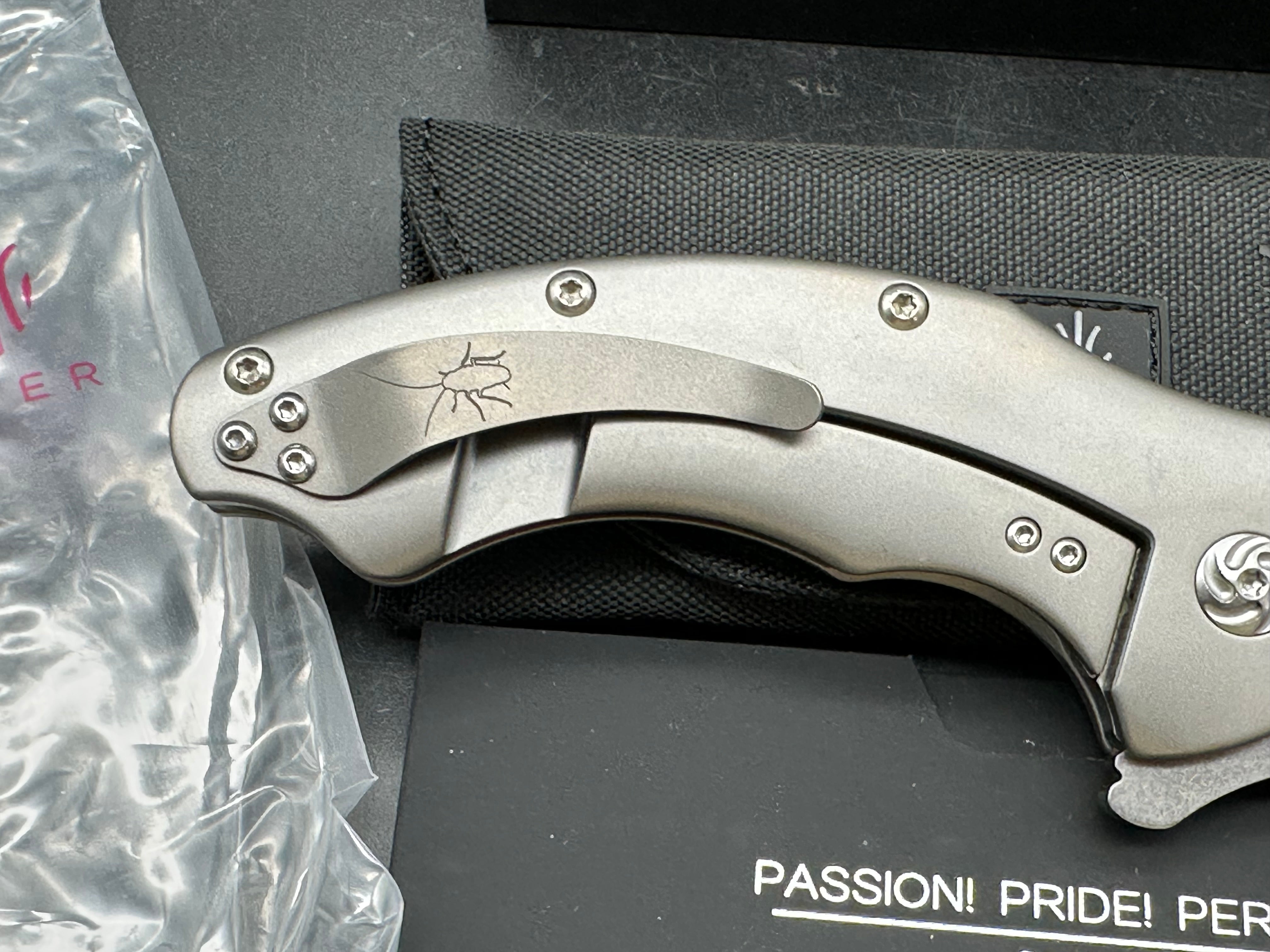 Kizer Roach Matt Degnan design 3.5 inch drop point flat grind, satin CPM-S35VN blade Titanium scales and clip with Roach insignia
