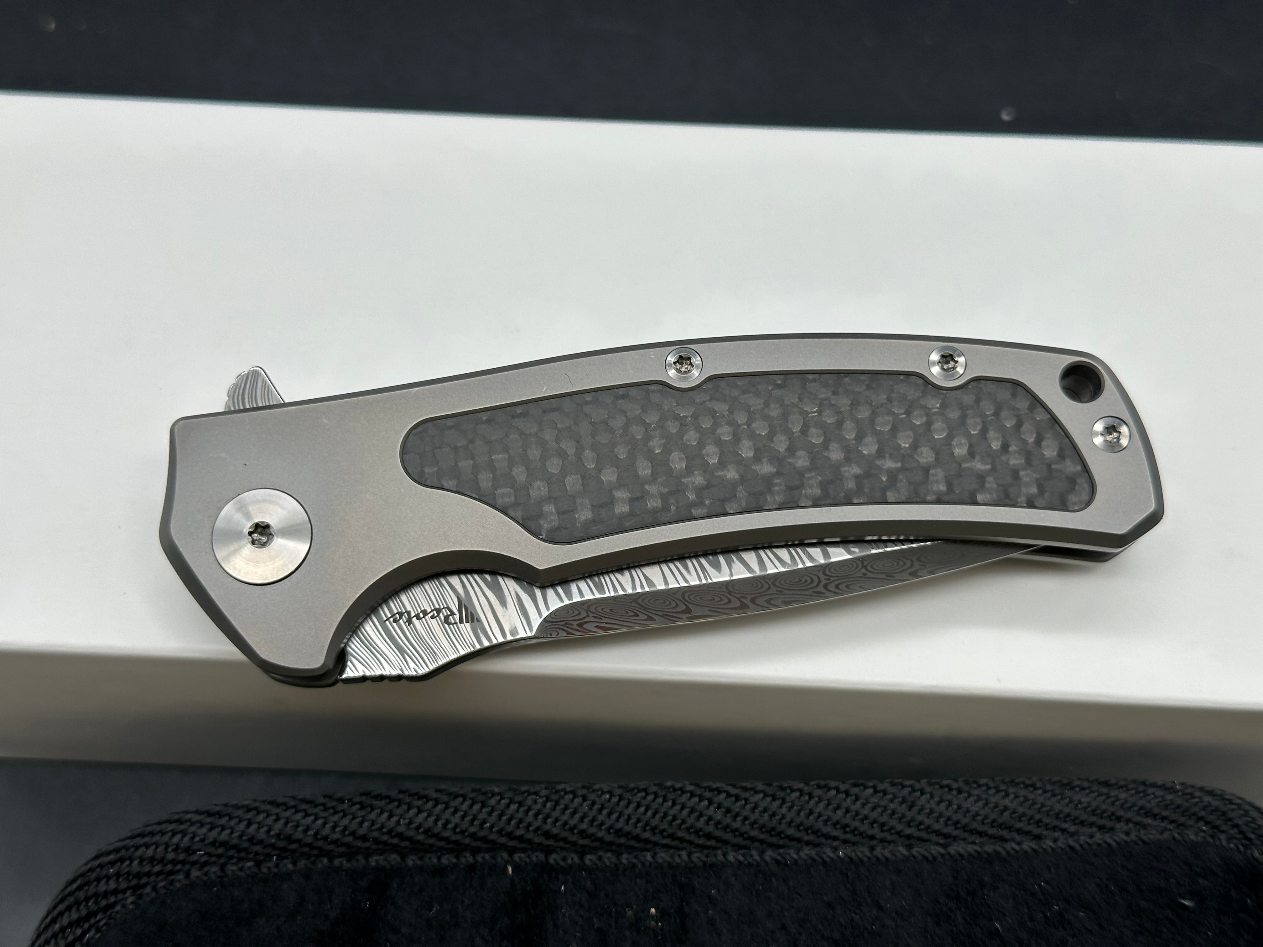 Reate Mini Horizon D: 3.5 inch drop point Damascus blade. 3D machined titanium handle with carbon fiber inlay
