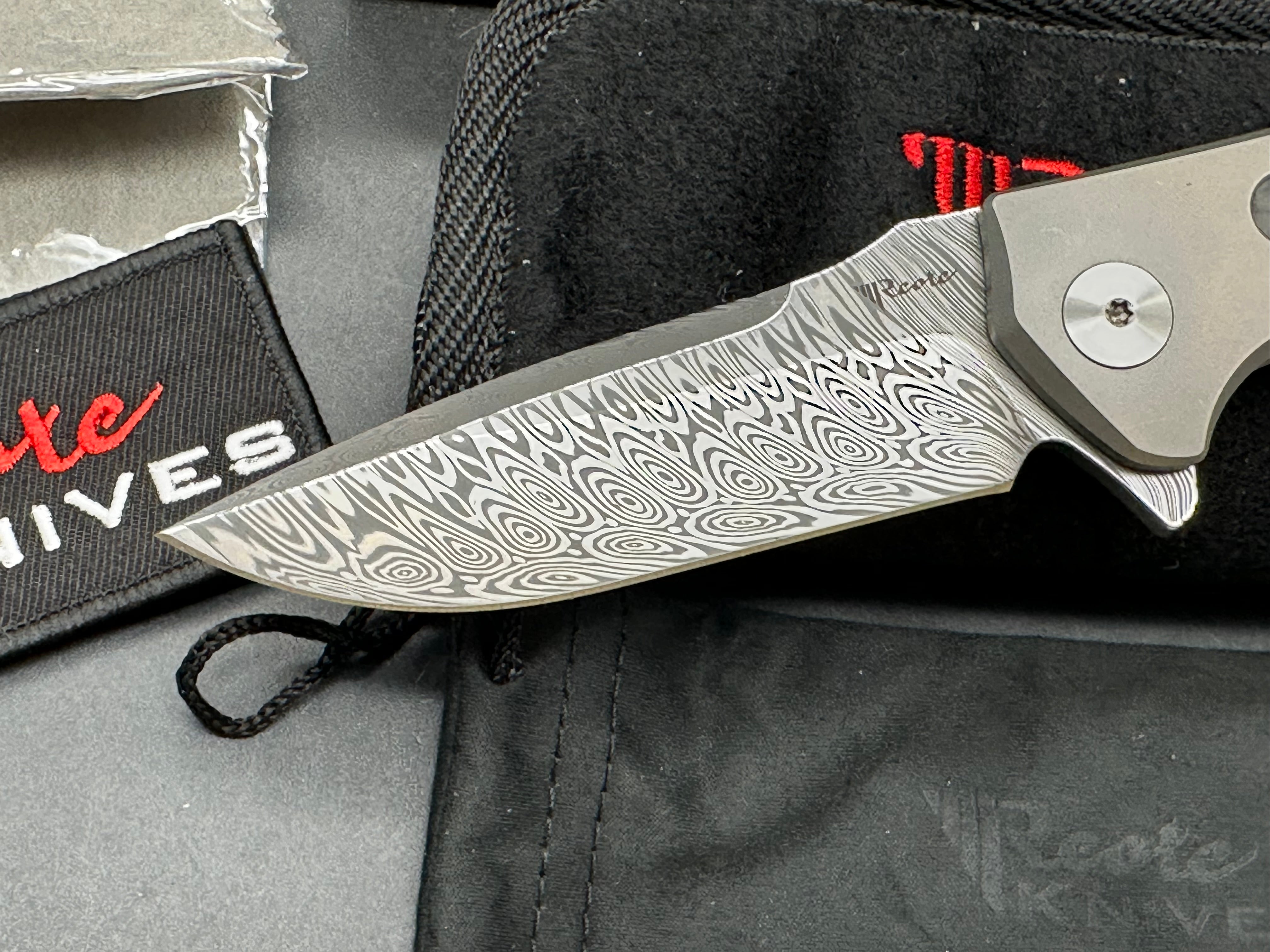 Reate Mini Horizon D: 3.5 inch drop point Damascus blade. 3D machined titanium handle with carbon fiber inlay