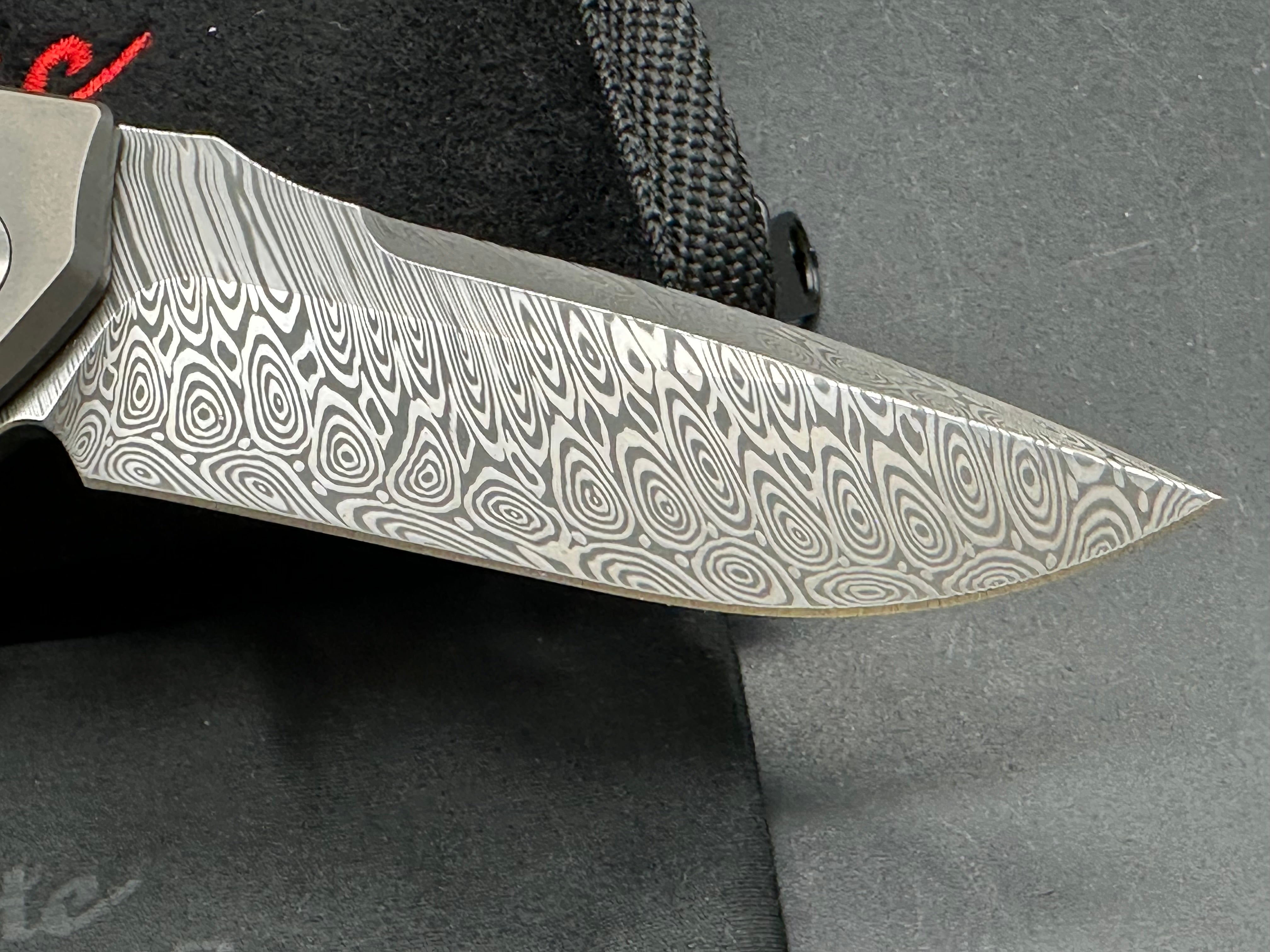 Reate Mini Horizon D: 3.5 inch drop point Damascus blade. 3D machined titanium handle with carbon fiber inlay