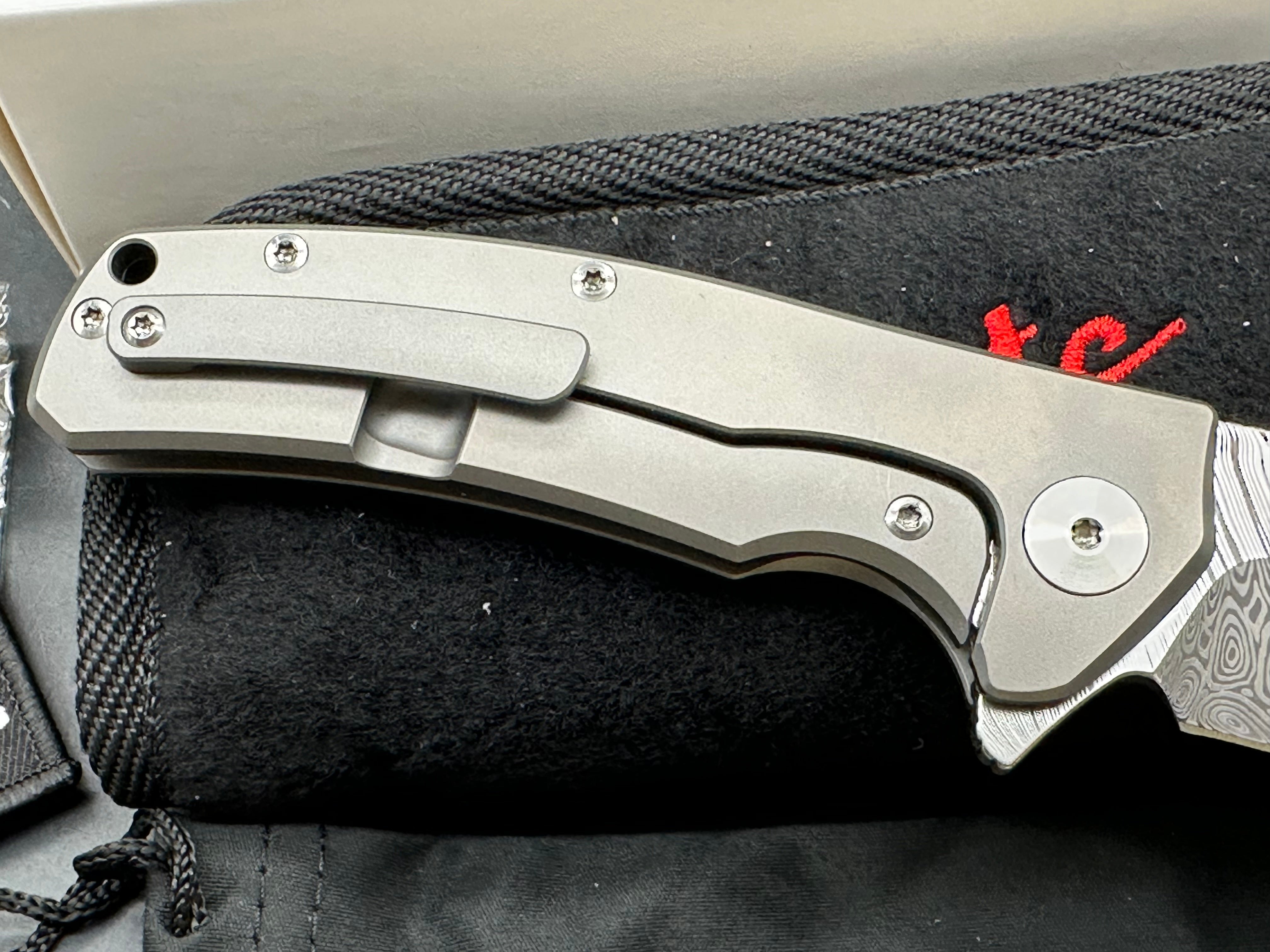 Reate Mini Horizon D: 3.5 inch drop point Damascus blade. 3D machined titanium handle with carbon fiber inlay