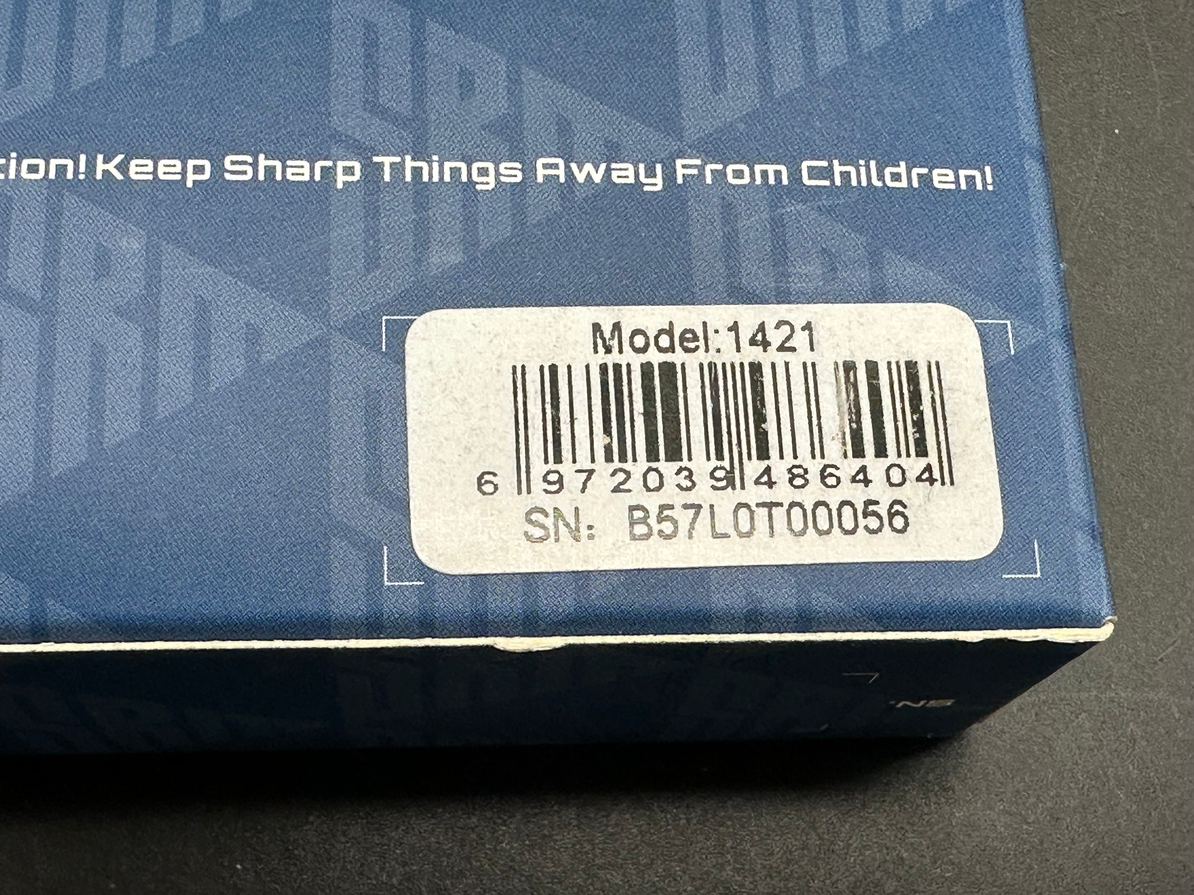 SRM model 1421: 3.63 inch N690 blade. Titanium frame with tan G10 insert